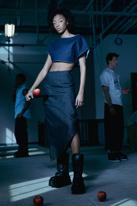 Model wearing 2nd Skin skirt in carbon raw denim with asymmetric layered silhouette