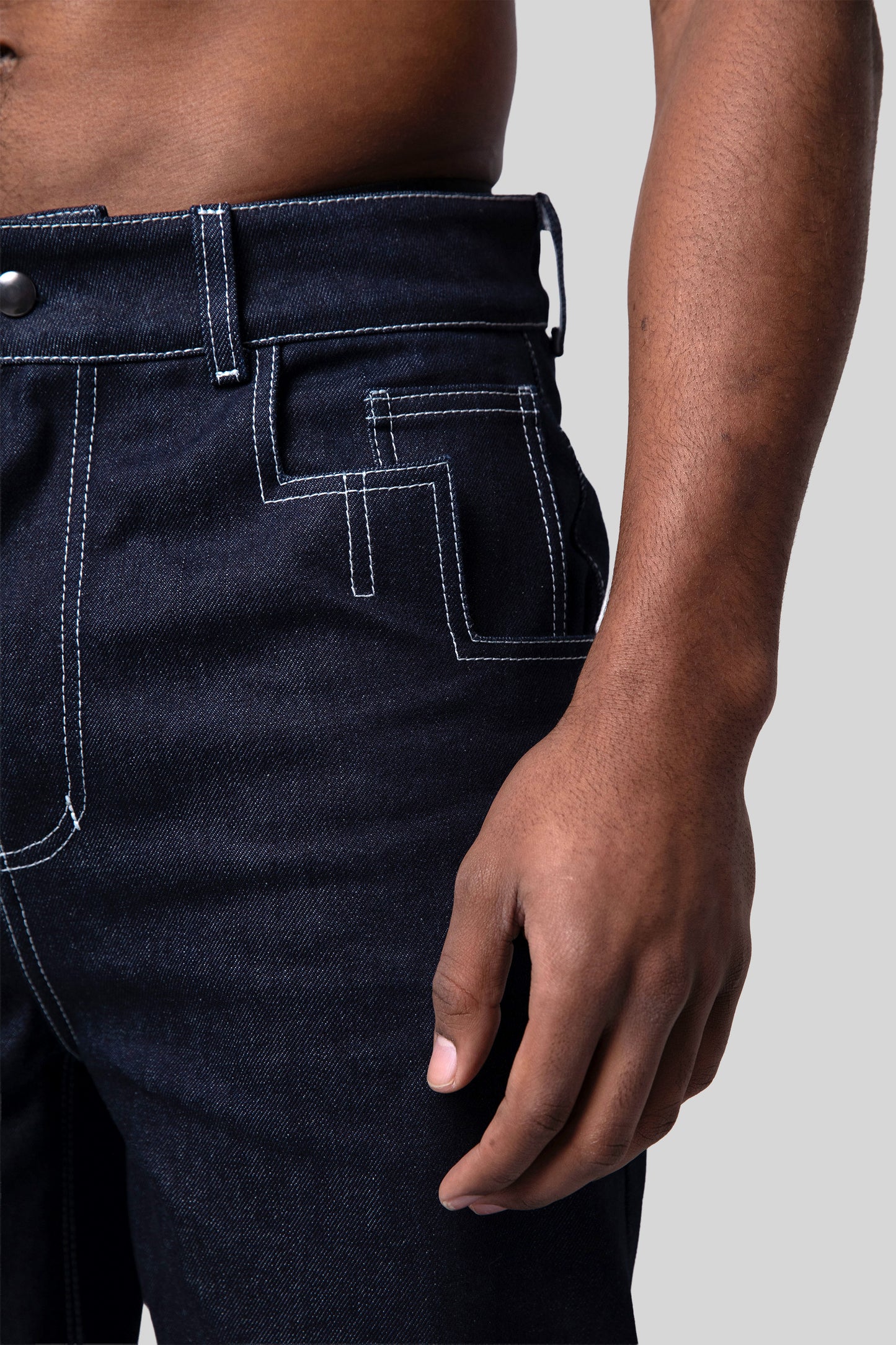Close-up of front pocket shaped like number 4 on indigo 4Front jeans