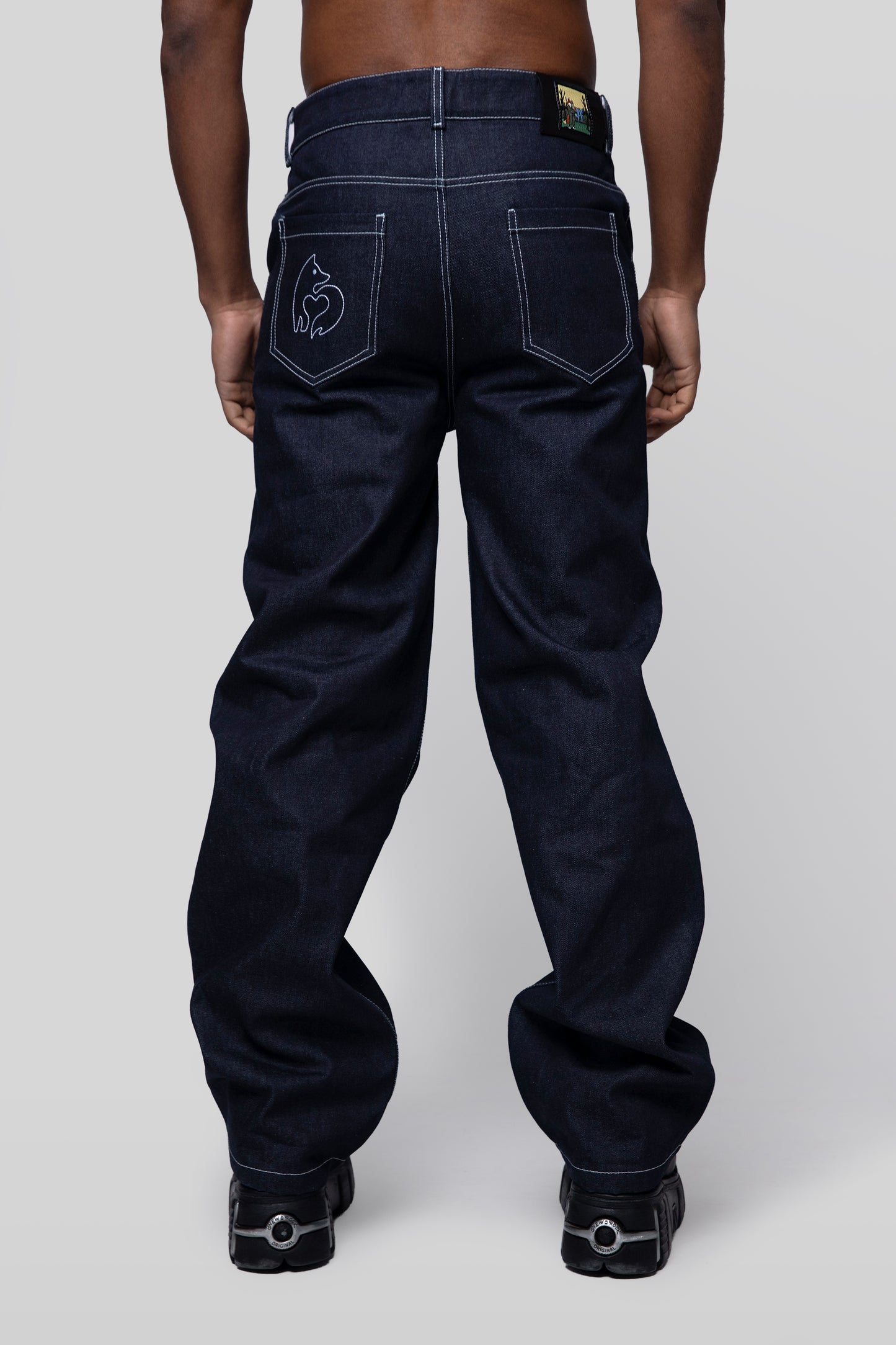Back view of indigo 4Front jeans with fox logo embroidery on pocket