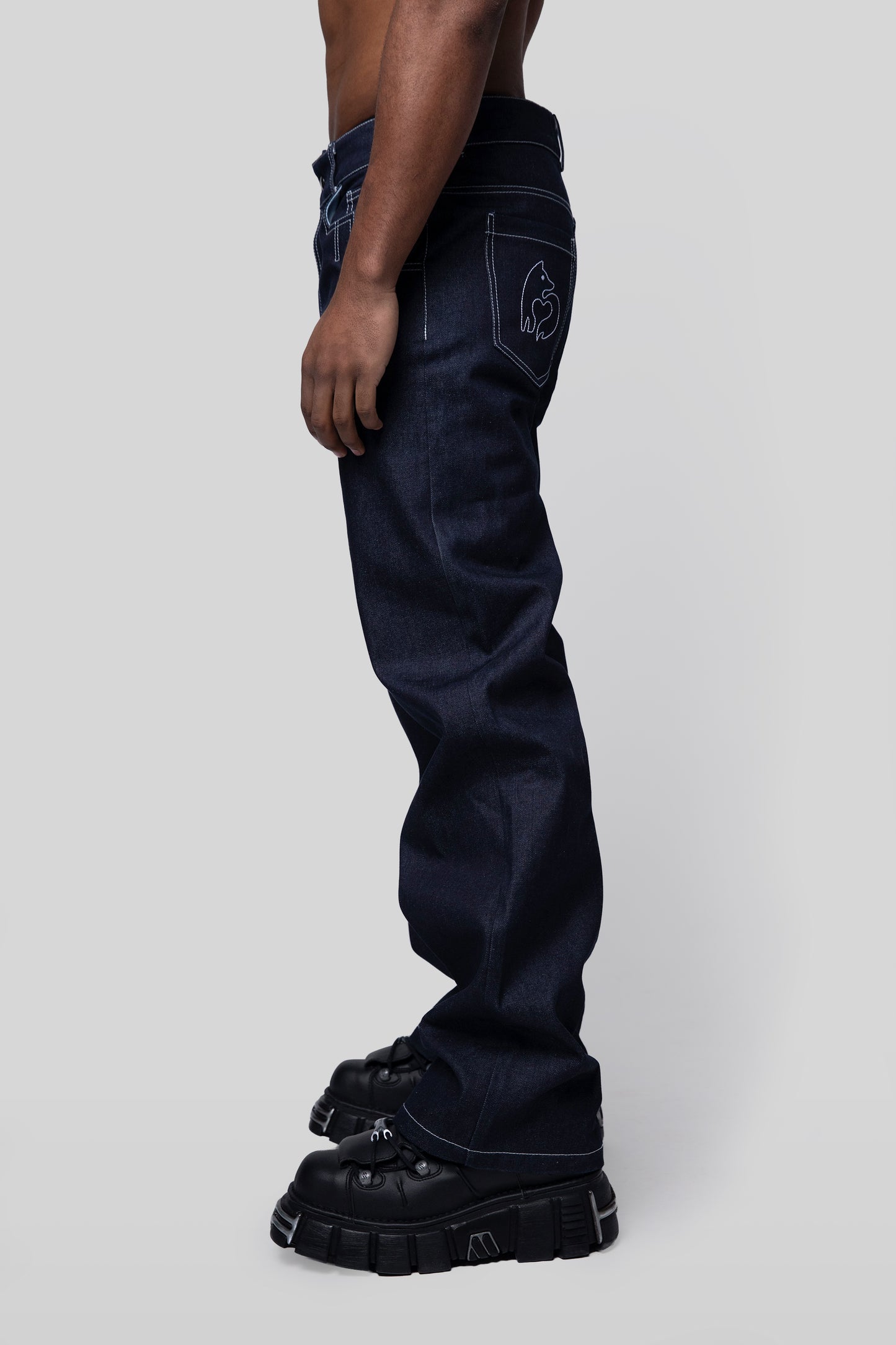 Alternate side view of indigo 4Front jeans with relaxed drape
