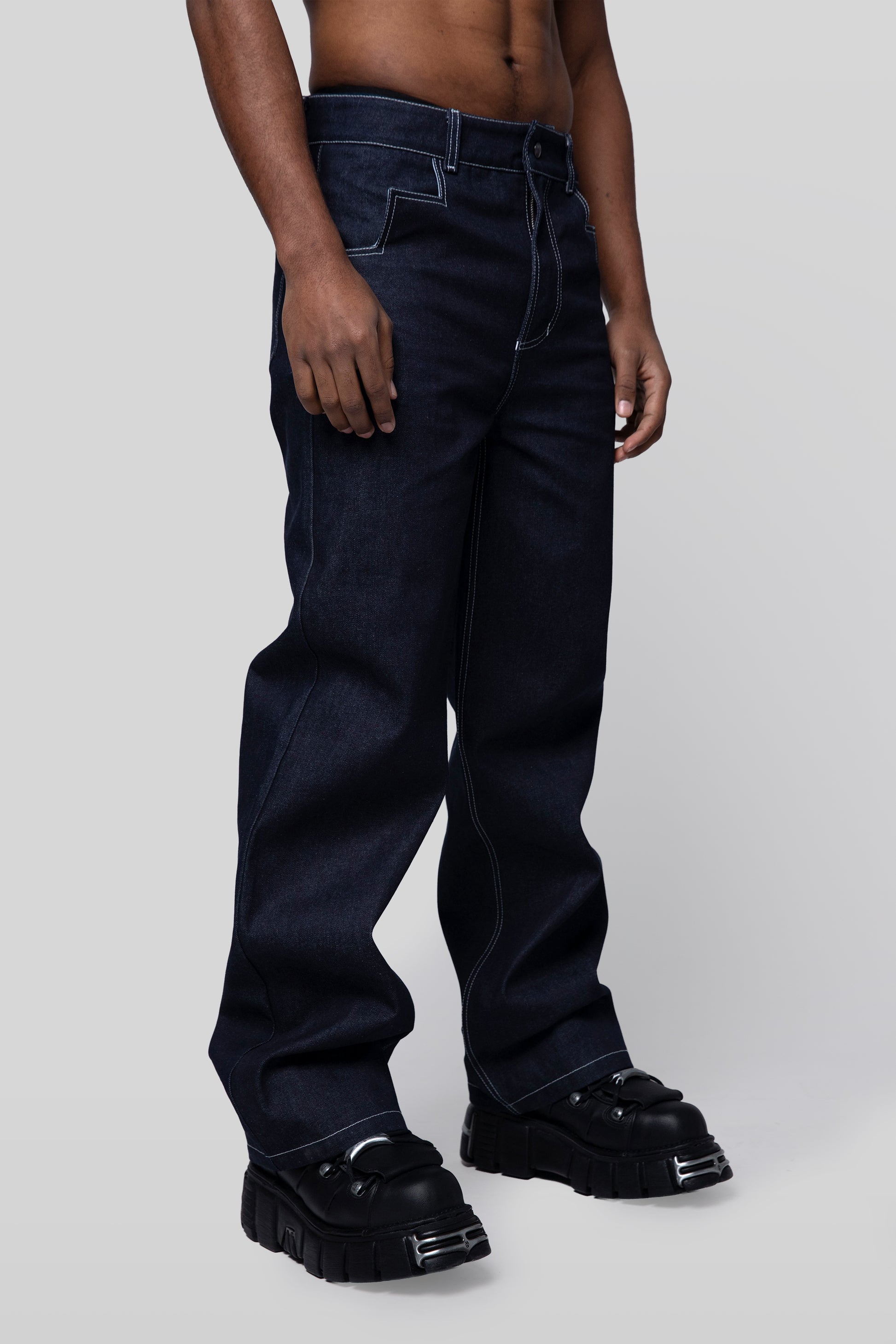 Angled side profile of 4Front jeans in indigo raw denim