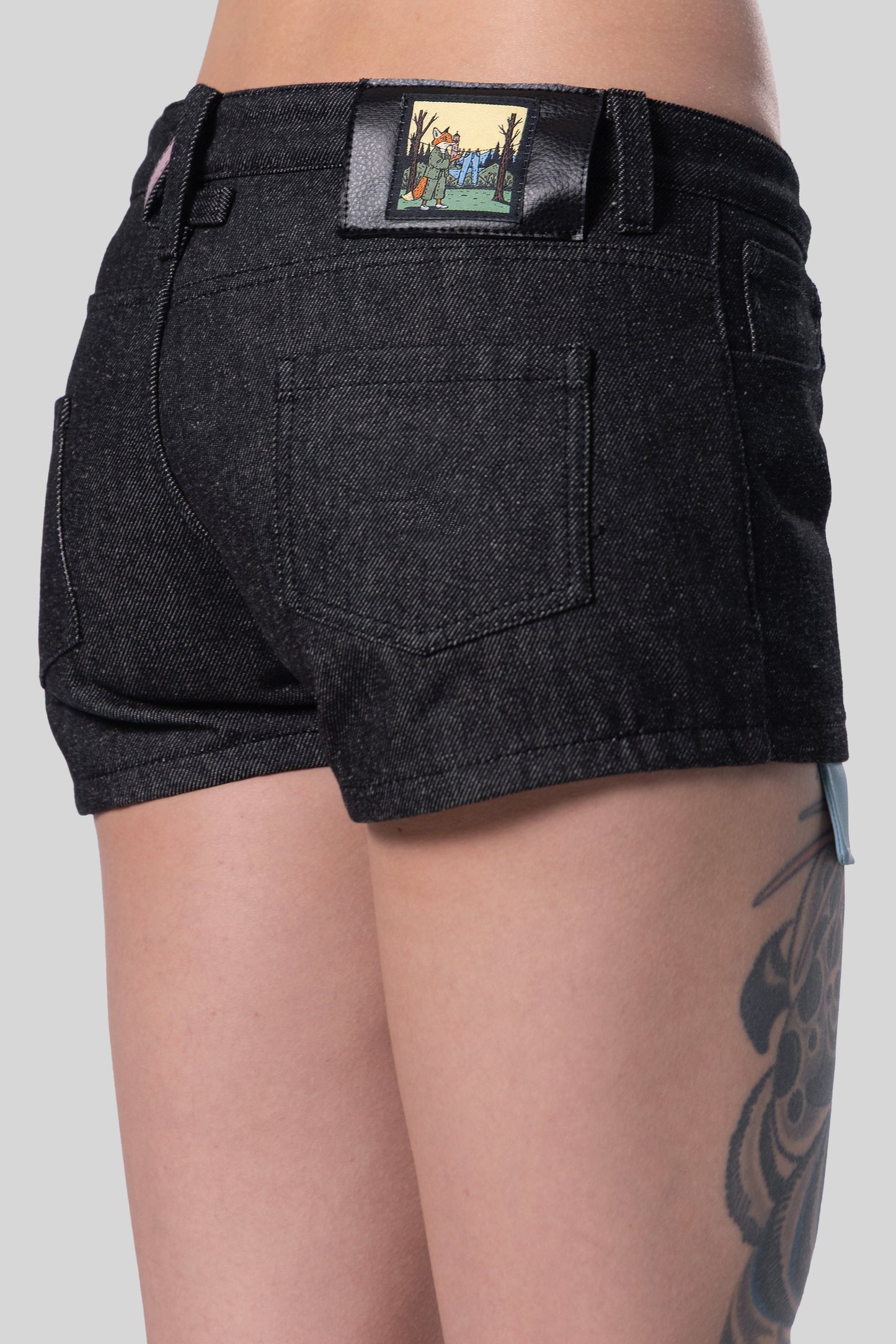 Close-up of back angled view of 4Sight shorts with fox illustration patch detail