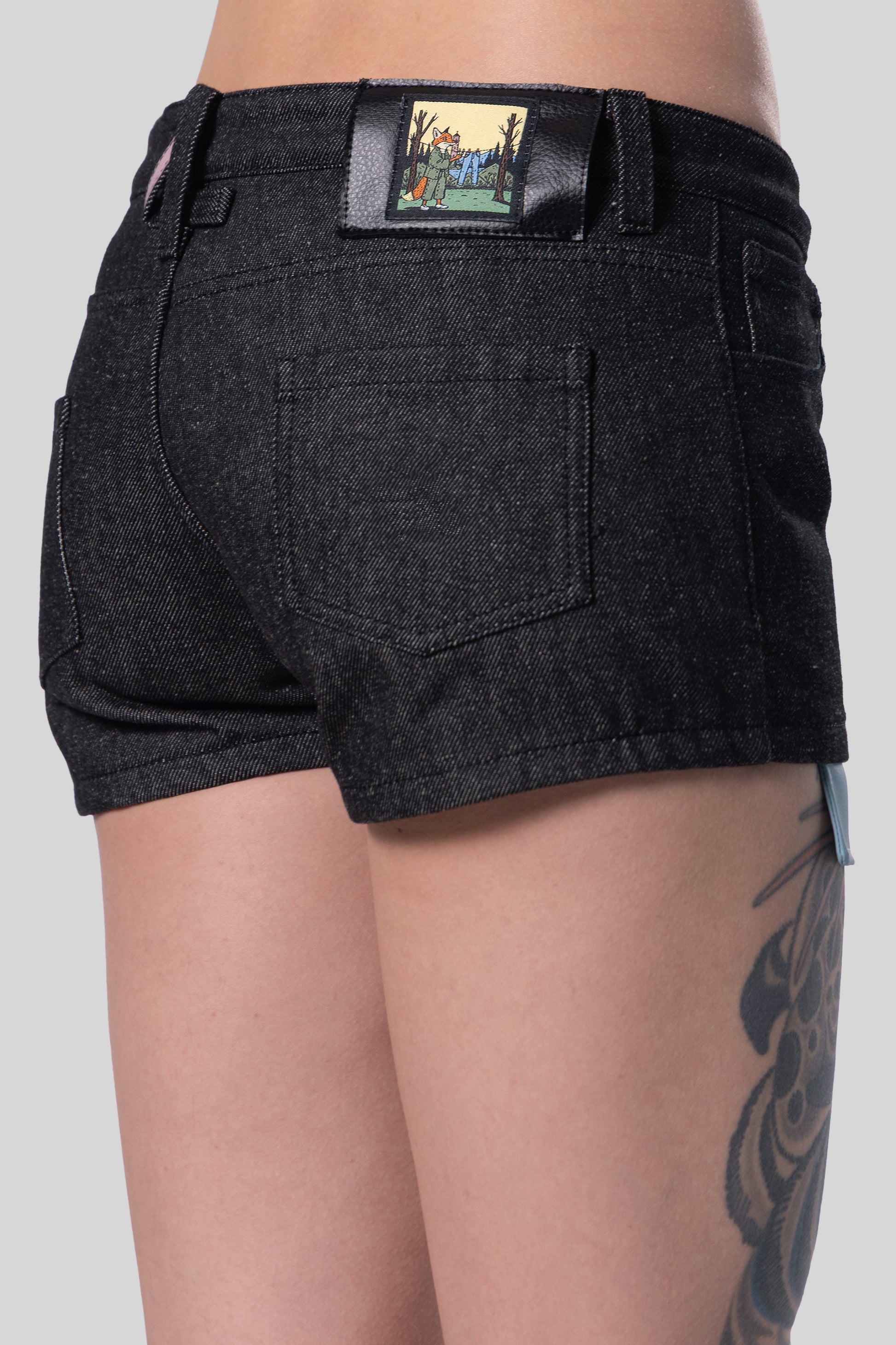 Close-up of back angled view of 4Sight shorts with fox illustration patch detail