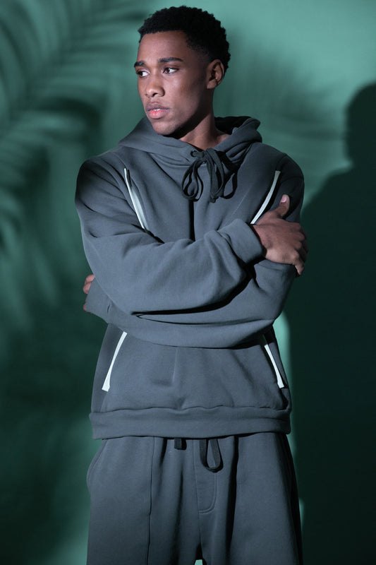 Model wearing 4NML Anchor hoodie in deep grey organic cotton with four-pocket design, relaxed fit