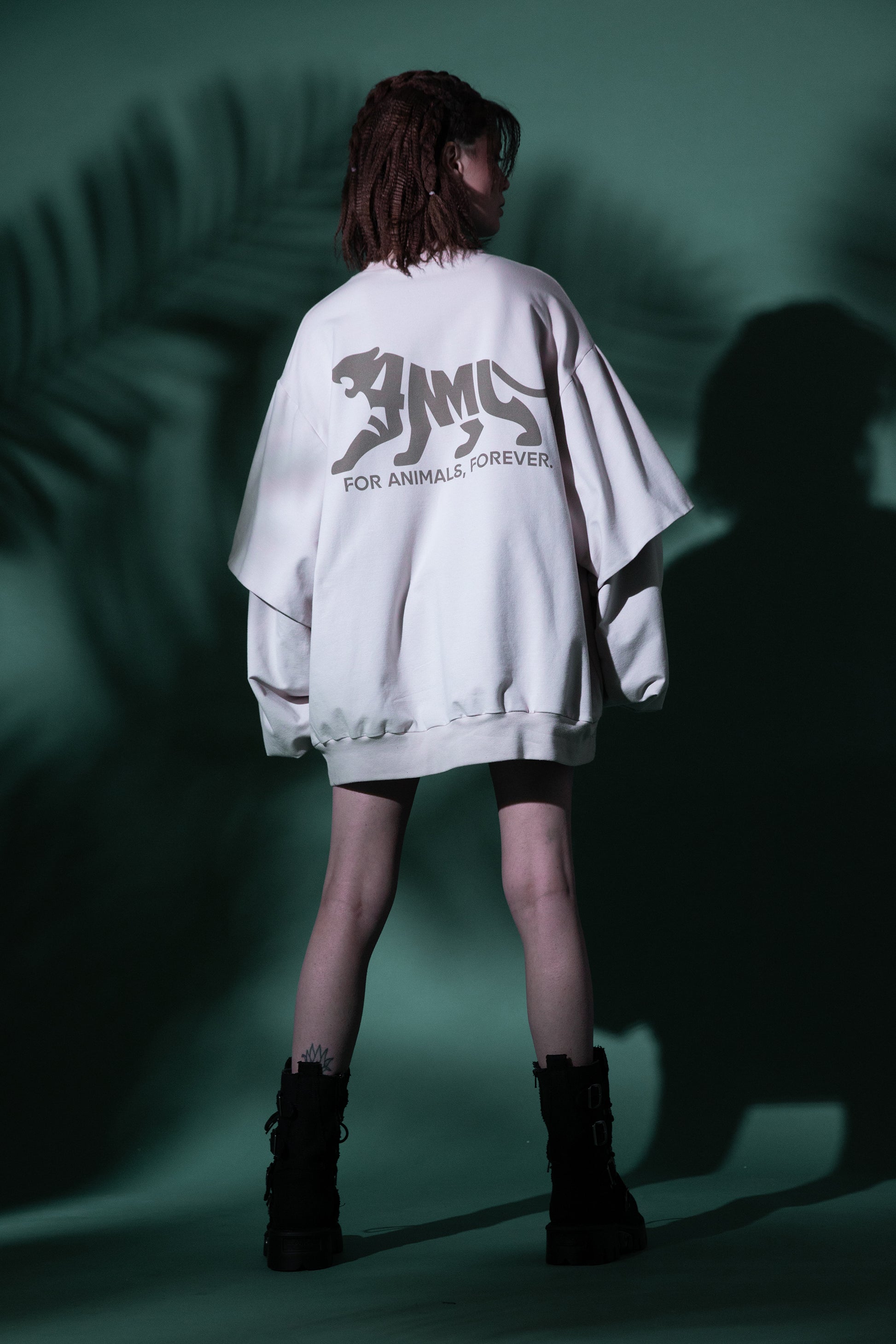[card:women-primary][card:all-primary] Model wearing 4NML Big Cat Crew sweatshirt in off-white organic cotton with tiger back print