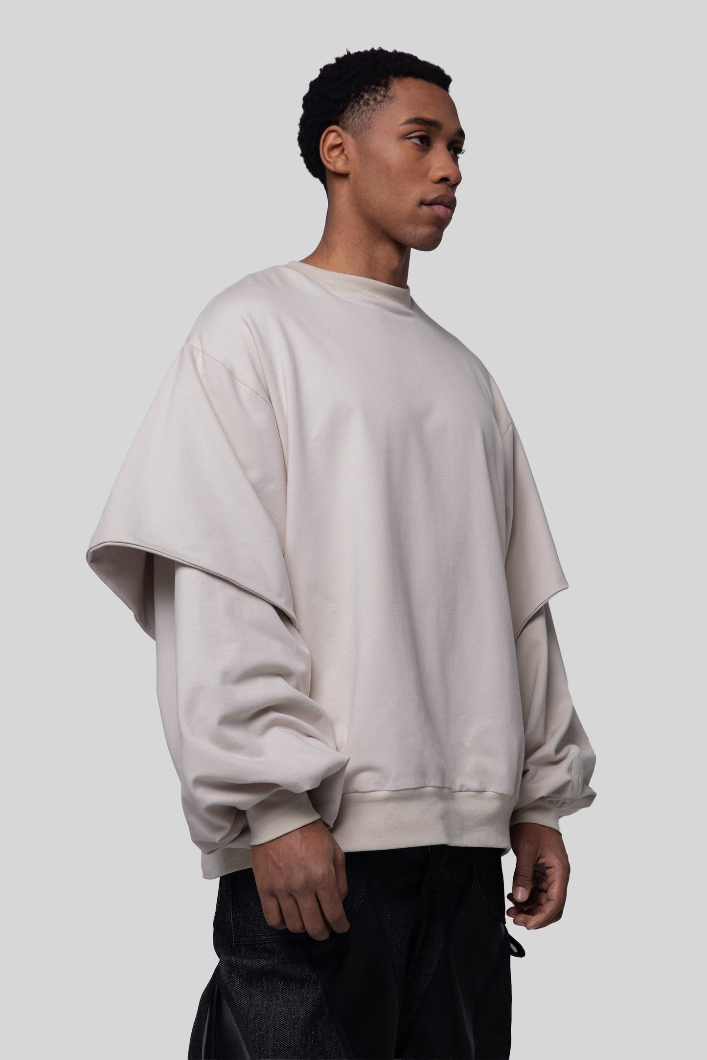 Angled front view of Big Cat Crew sweatshirt with oversized sleeves