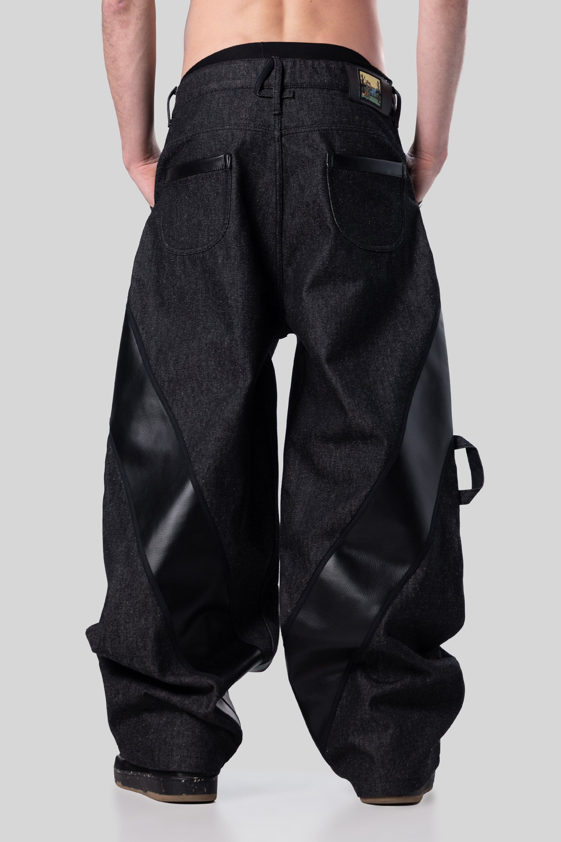[card:men-secondary][card:all-secondary] Back view of Bloom jeans in carbon raw denim with relaxed drape