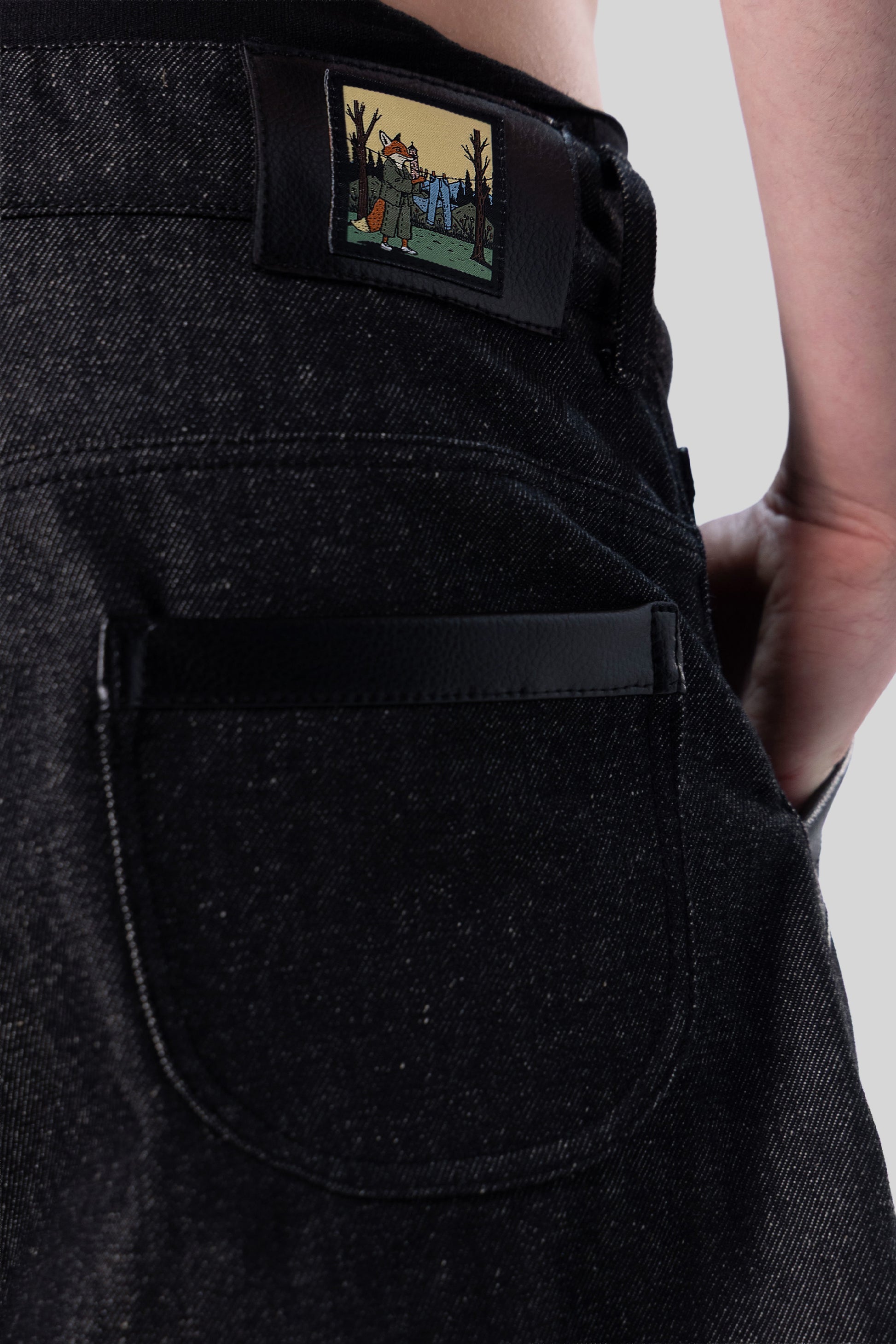 Close-up of fox illustration patch and back pocket on back of Bloom jeans