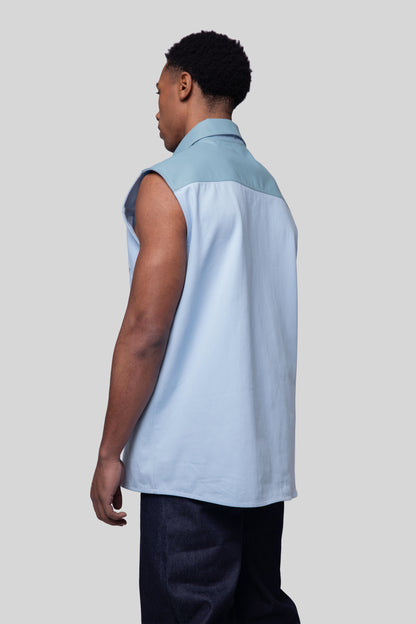 Back angled view of Blue Collar vest in light blue cotton twill with Stone Blue AppleSkin back panel and collar