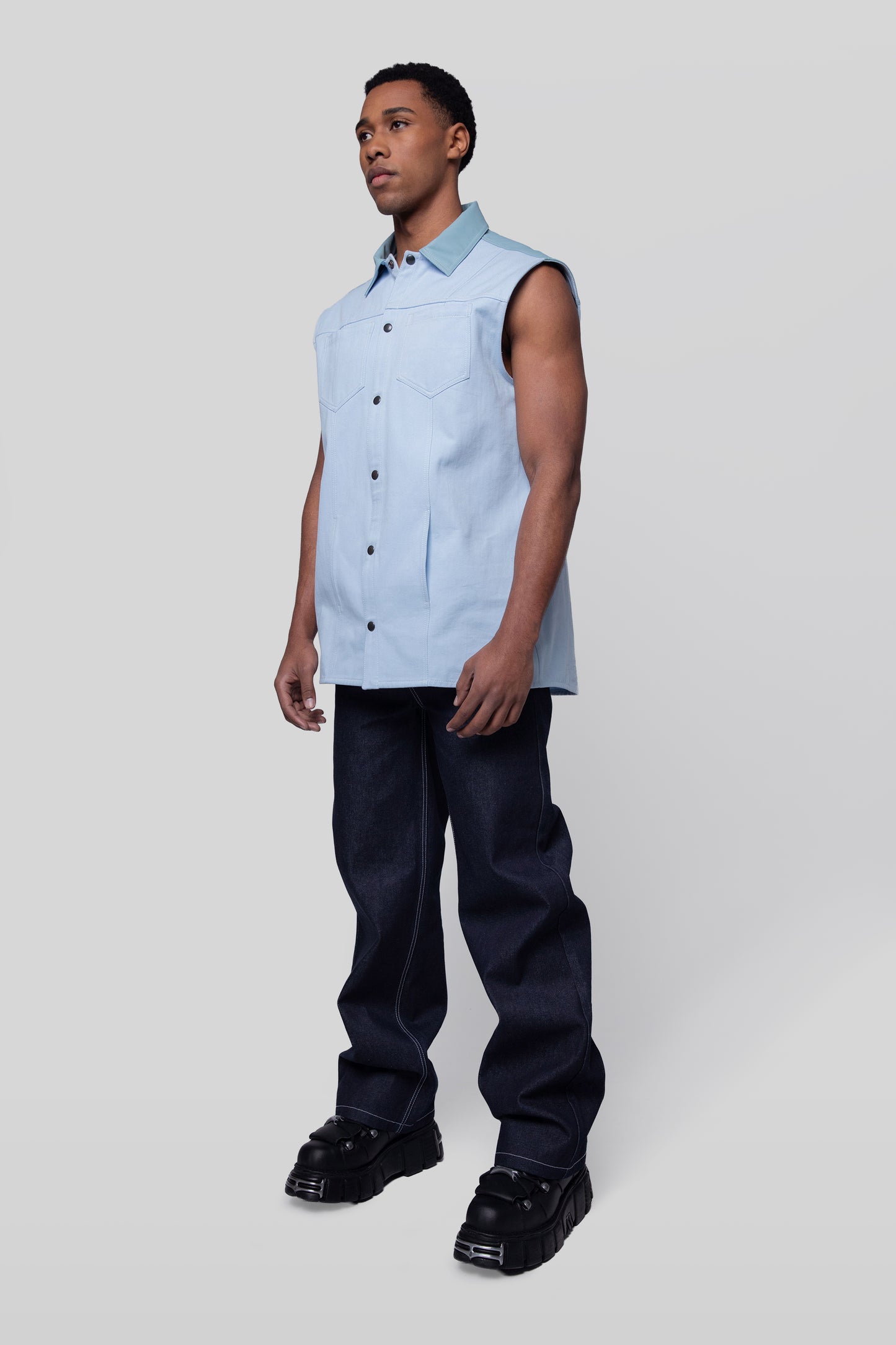 Angled full body view of Blue Collar vest in light blue cotton twill