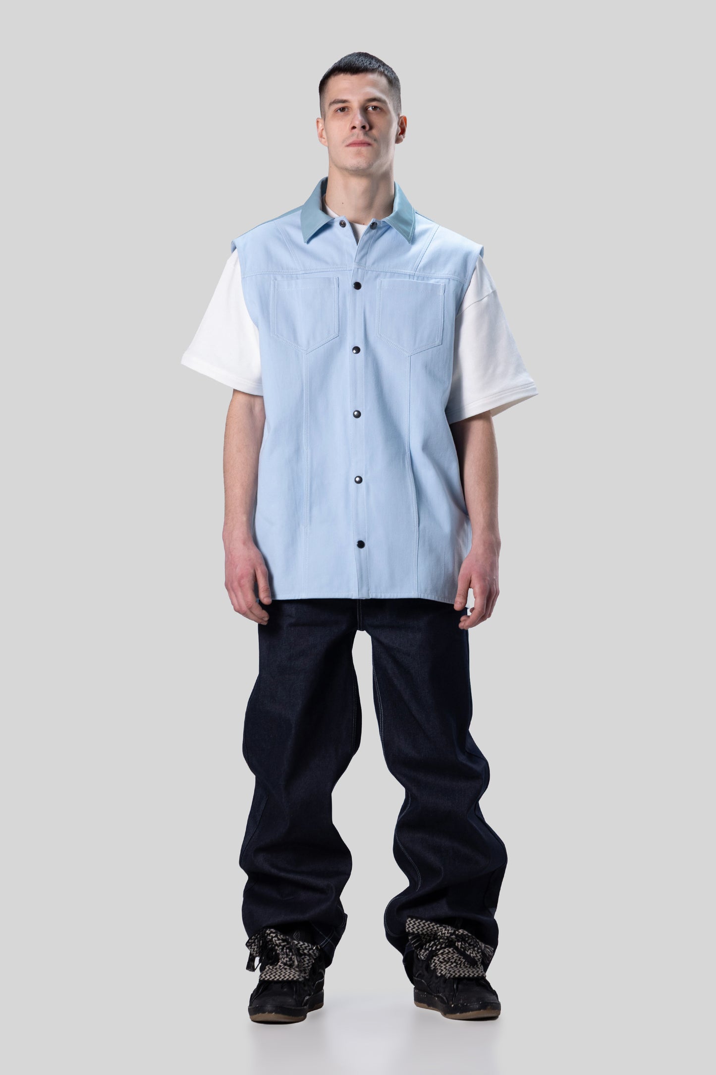 Model wearing Blue Collar vest layered over shirt, relaxed fit