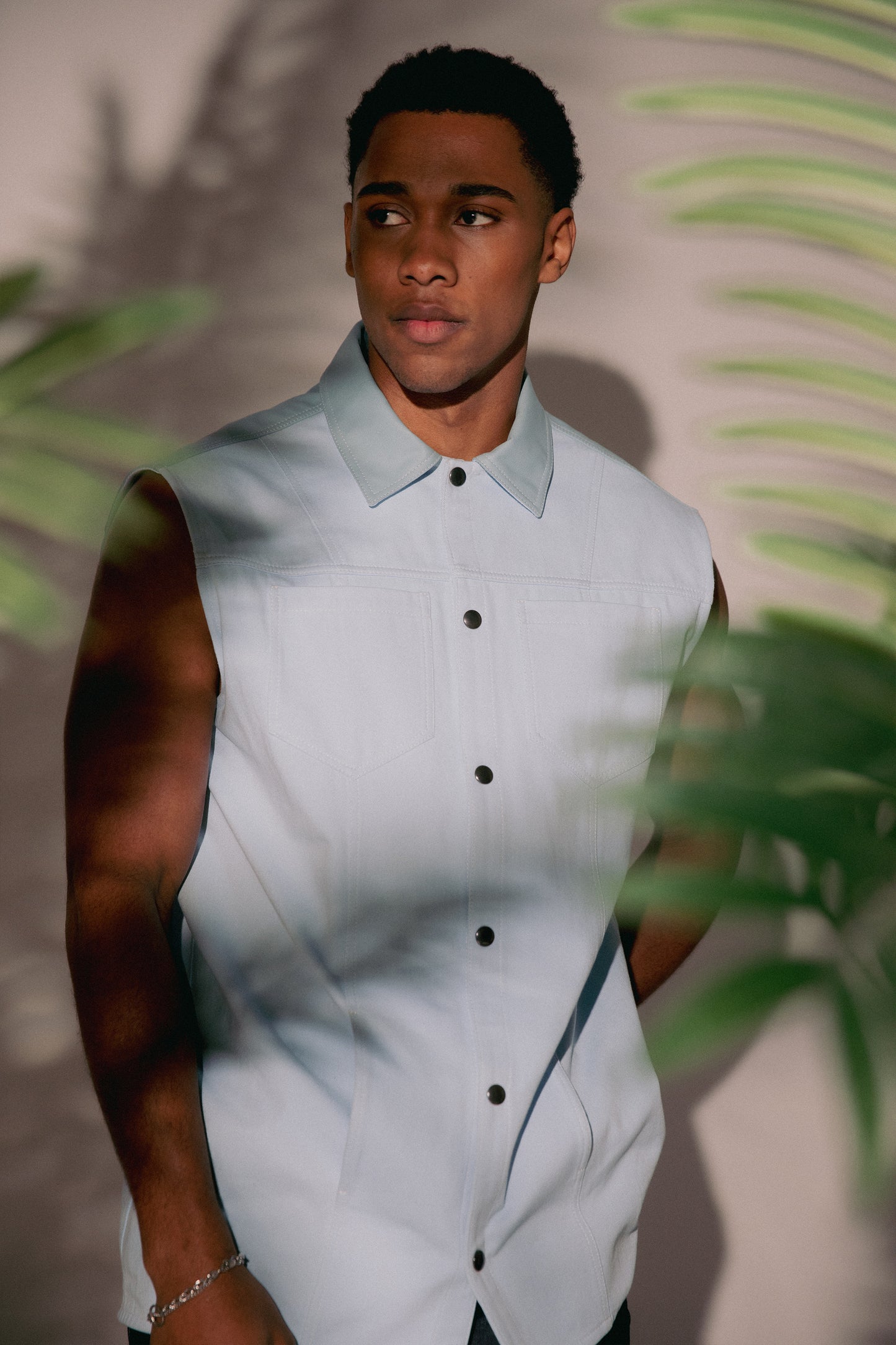 [card:men-primary][card:all-primary] Model wearing 4NML Blue Collar vest in light blue cotton twill with AppleSkin panel, relaxed fit