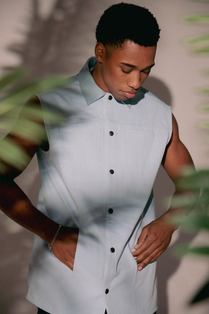 Portrait of Blue Collar vest in light blue with snap front and structured collar