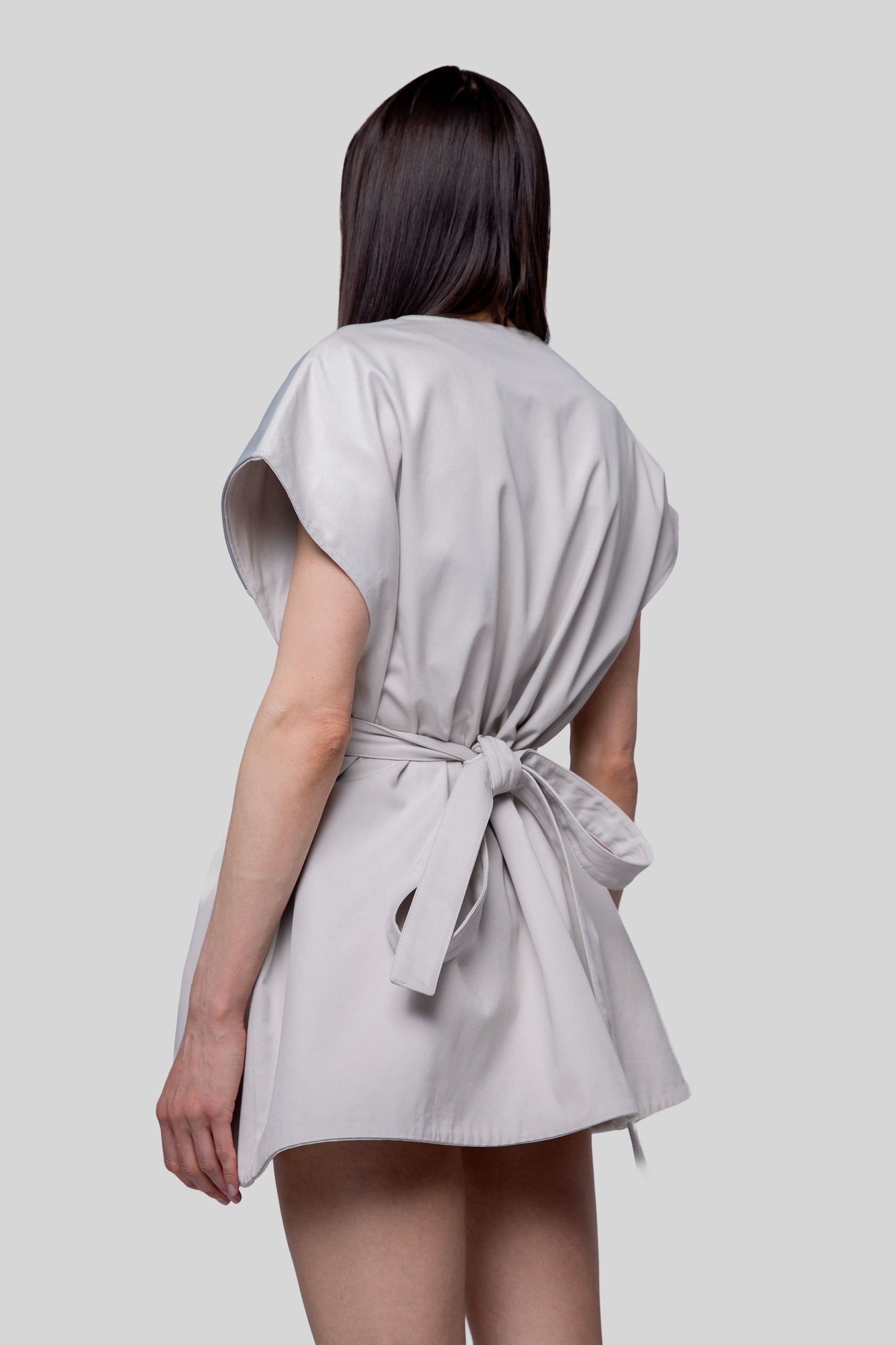 Back angled view of Chameleon dress with belt detail