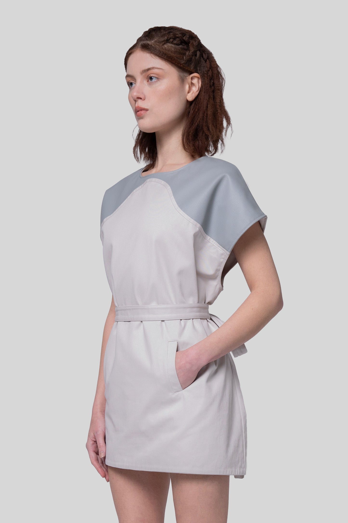 Angled portrait of Chameleon dress with hand in pocket, fitted look