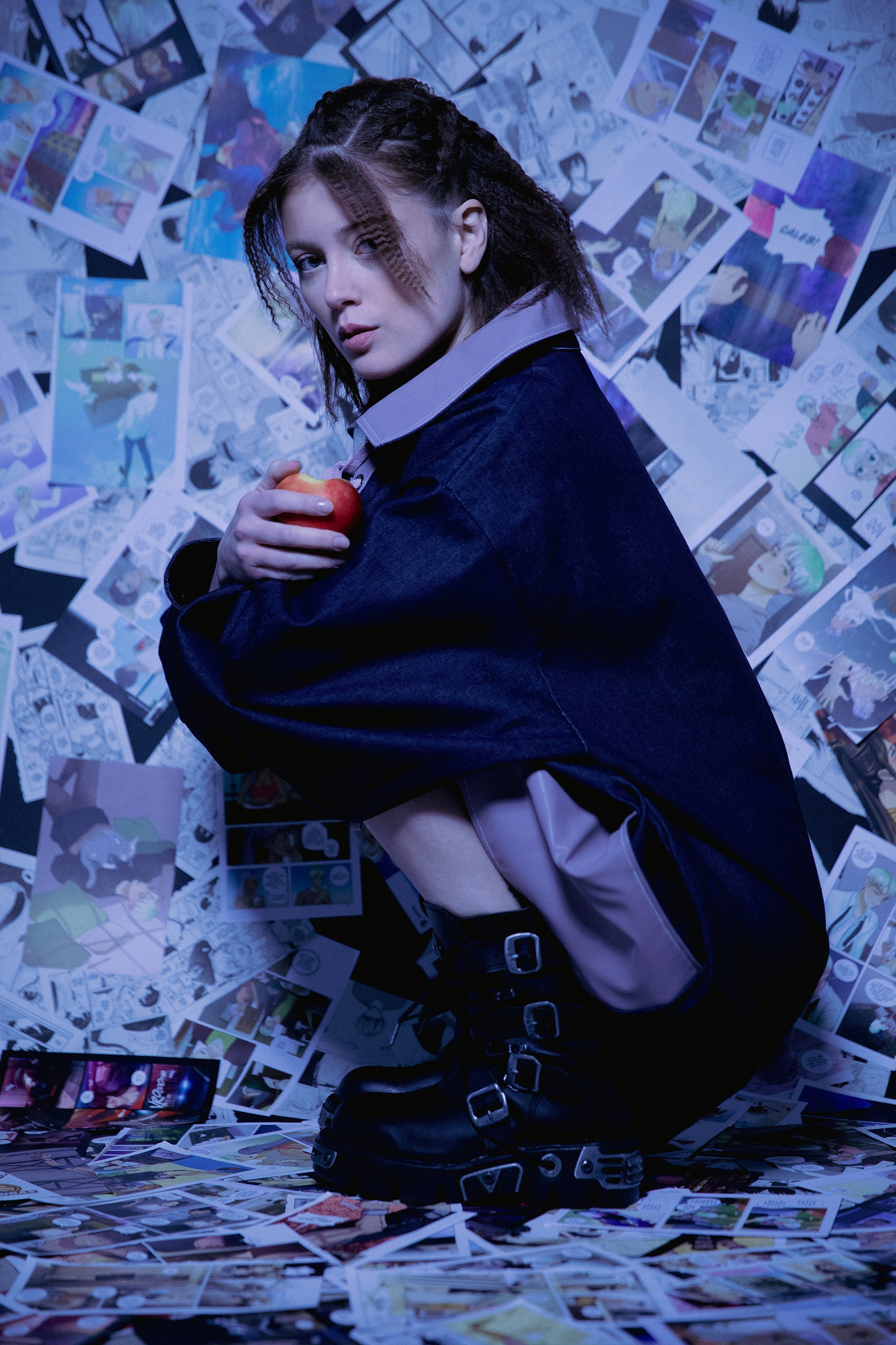 Model crouching in indigo raw denim Dovetail Dress with purple AppleSkin front panel