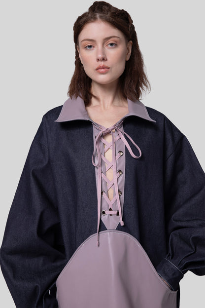 Close-up of indigo Dovetail Dress with purple AppleSkin panel and lace-up detail