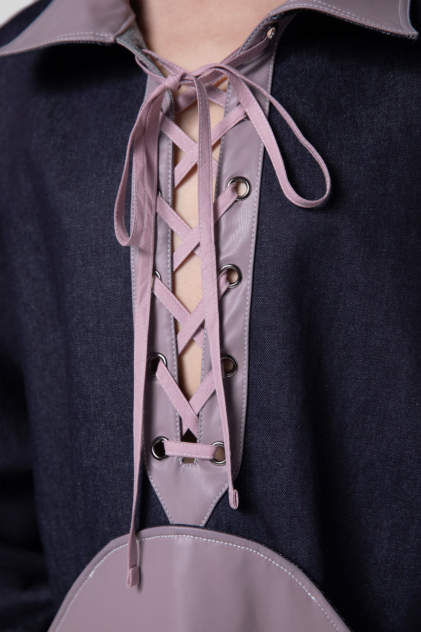 Close-up of lace-up front detail on purple AppleSkin panel of Dovetail Dress