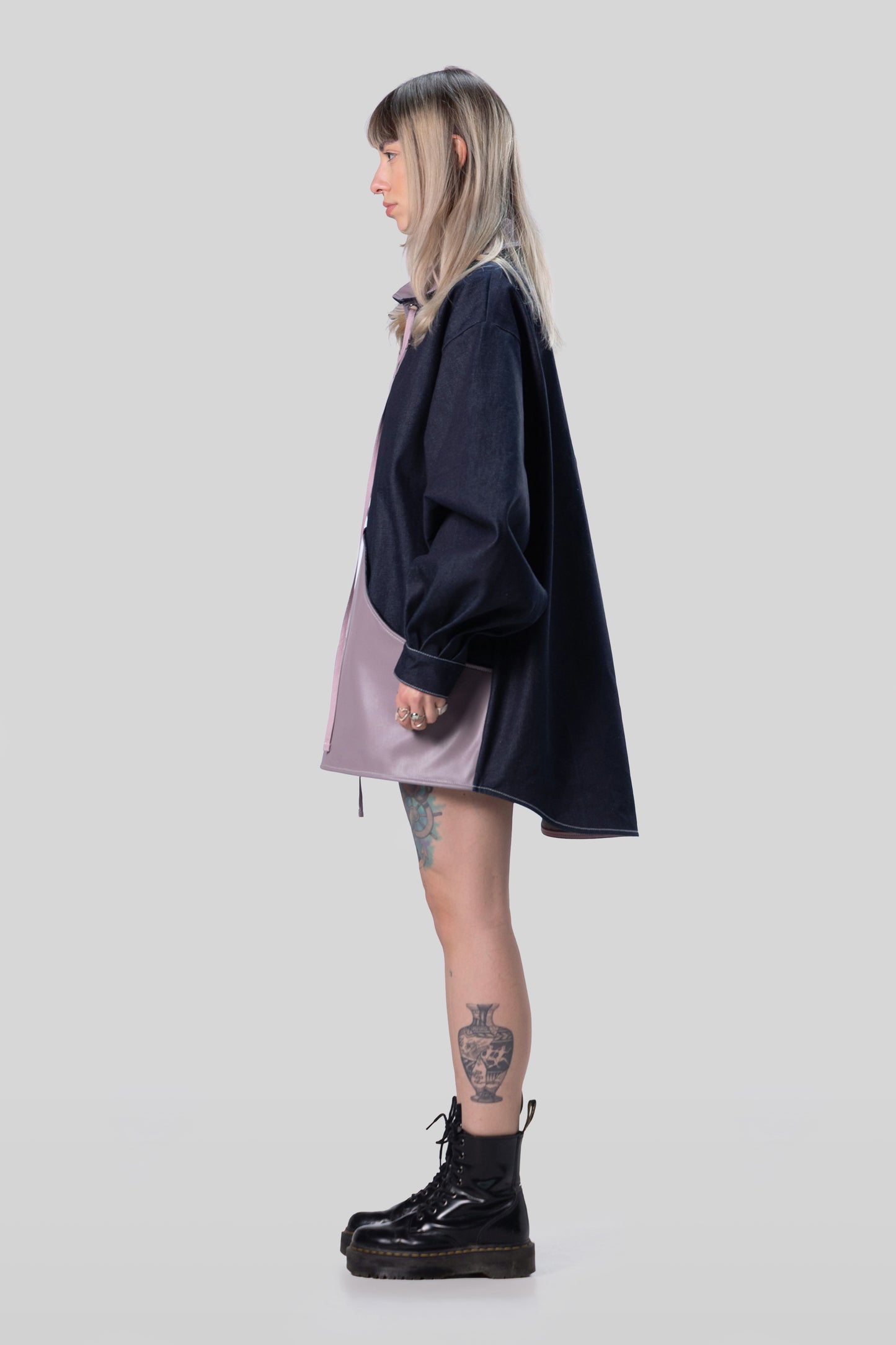 Side profile of indigo raw denim Dovetail Dress with structured silhouette