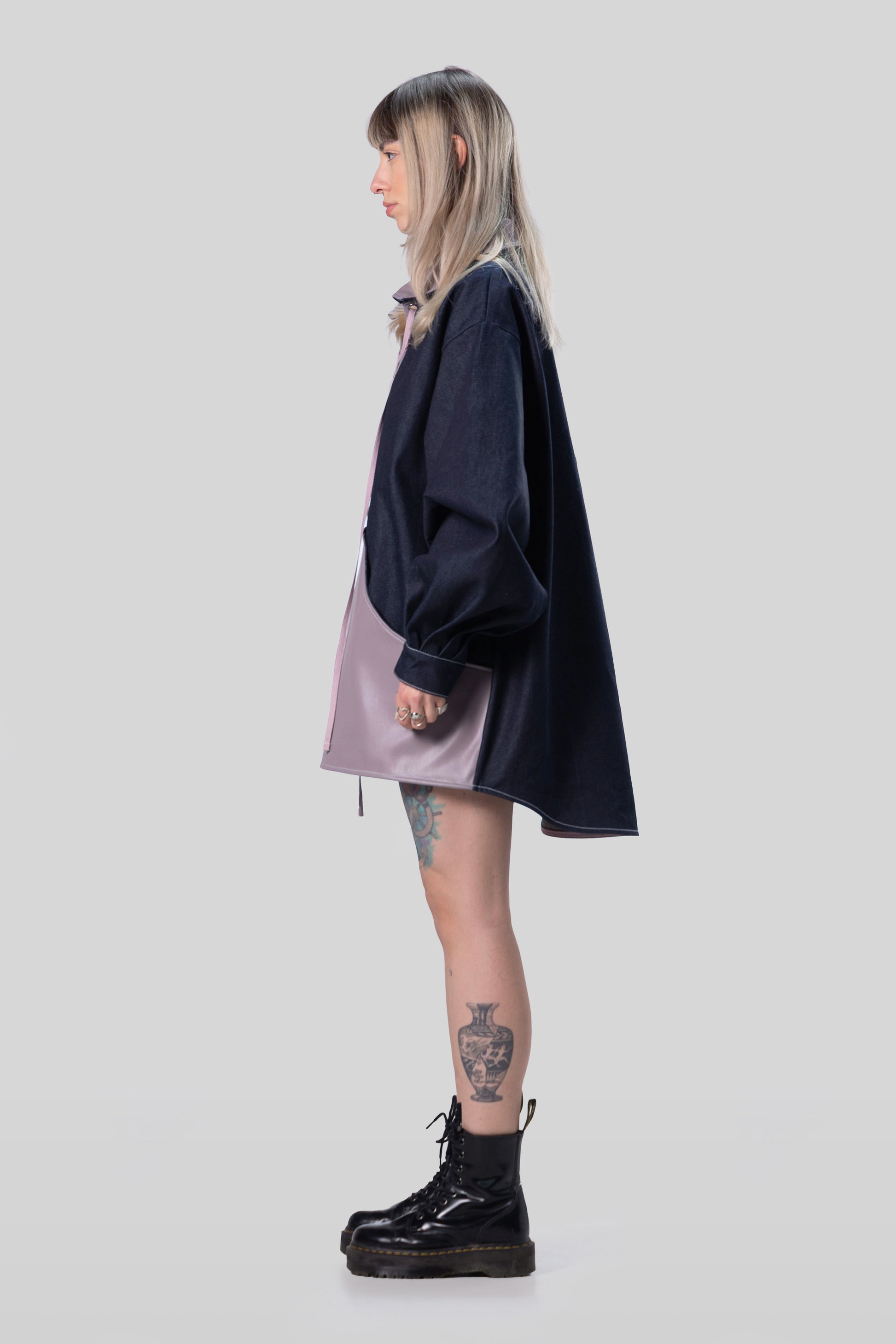 Side profile of indigo raw denim Dovetail Dress with structured silhouette