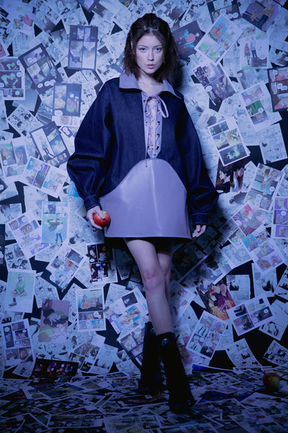 Model standing in indigo Candiani raw denim Dovetail Dress with purple AppleSkin panel