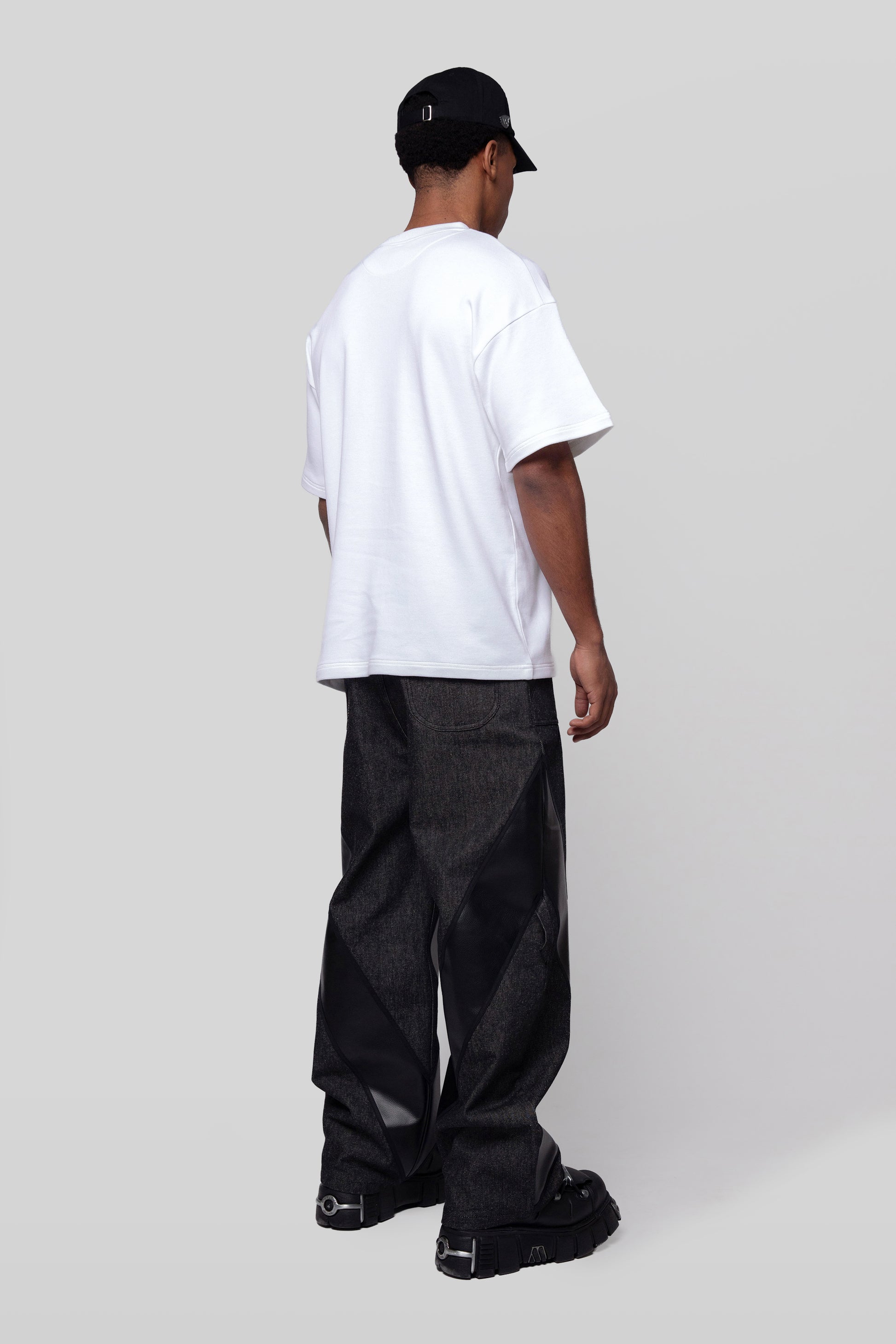 Back angled view of white Supima cotton Lineage Tee, minimal rear design