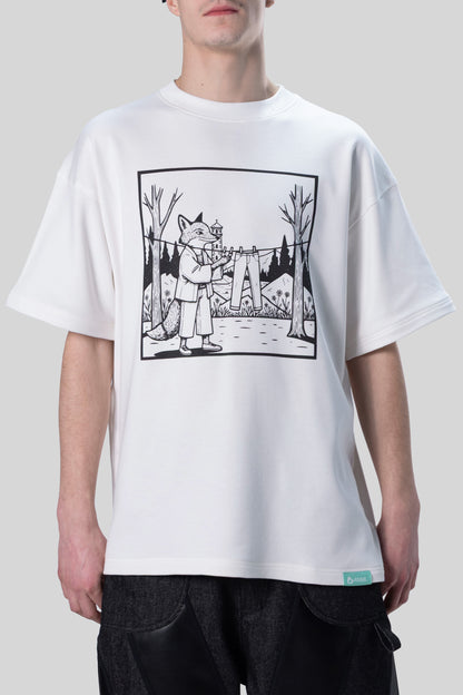 [card:men-secondary][card:all-secondary] Model wearing 4NML Men's Lineage Tee, front view showing illustration of fox hanging jeans on clothes line