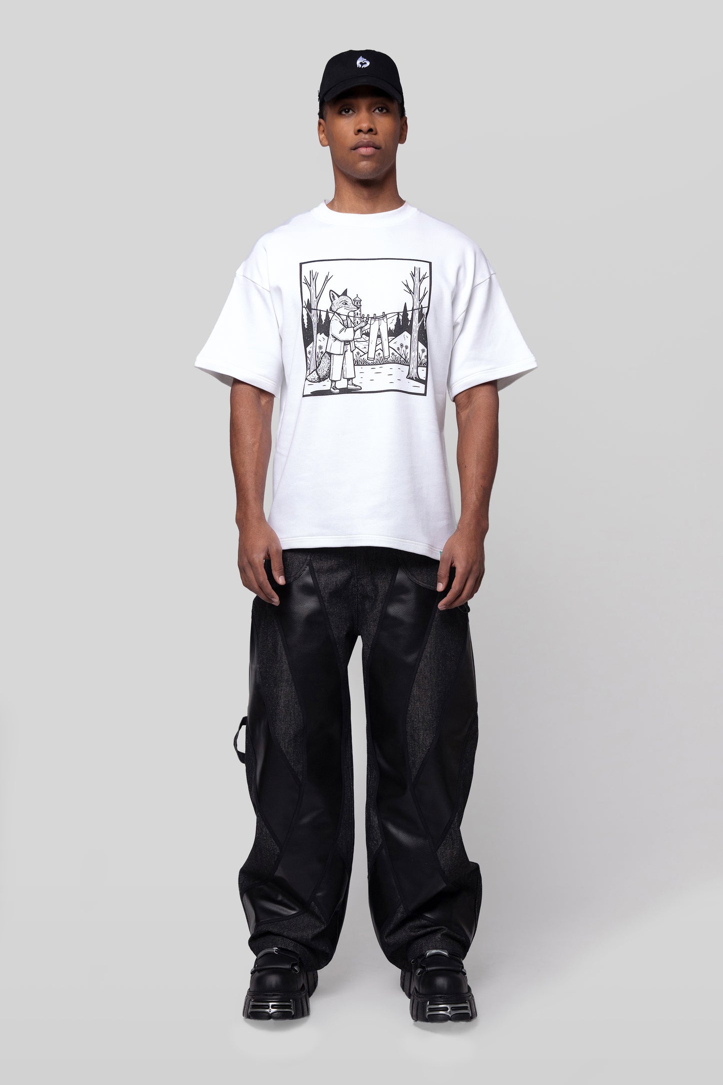 Full body front view of white Supima cotton Lineage Tee with black DTG graphic