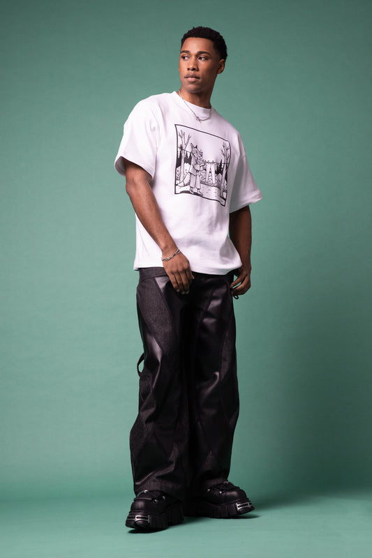 Model standing in white Supima cotton Lineage Tee with black graphic and 4NML Bloom Jean in carbon Candiani raw denim with black AppleSkin panels, full body