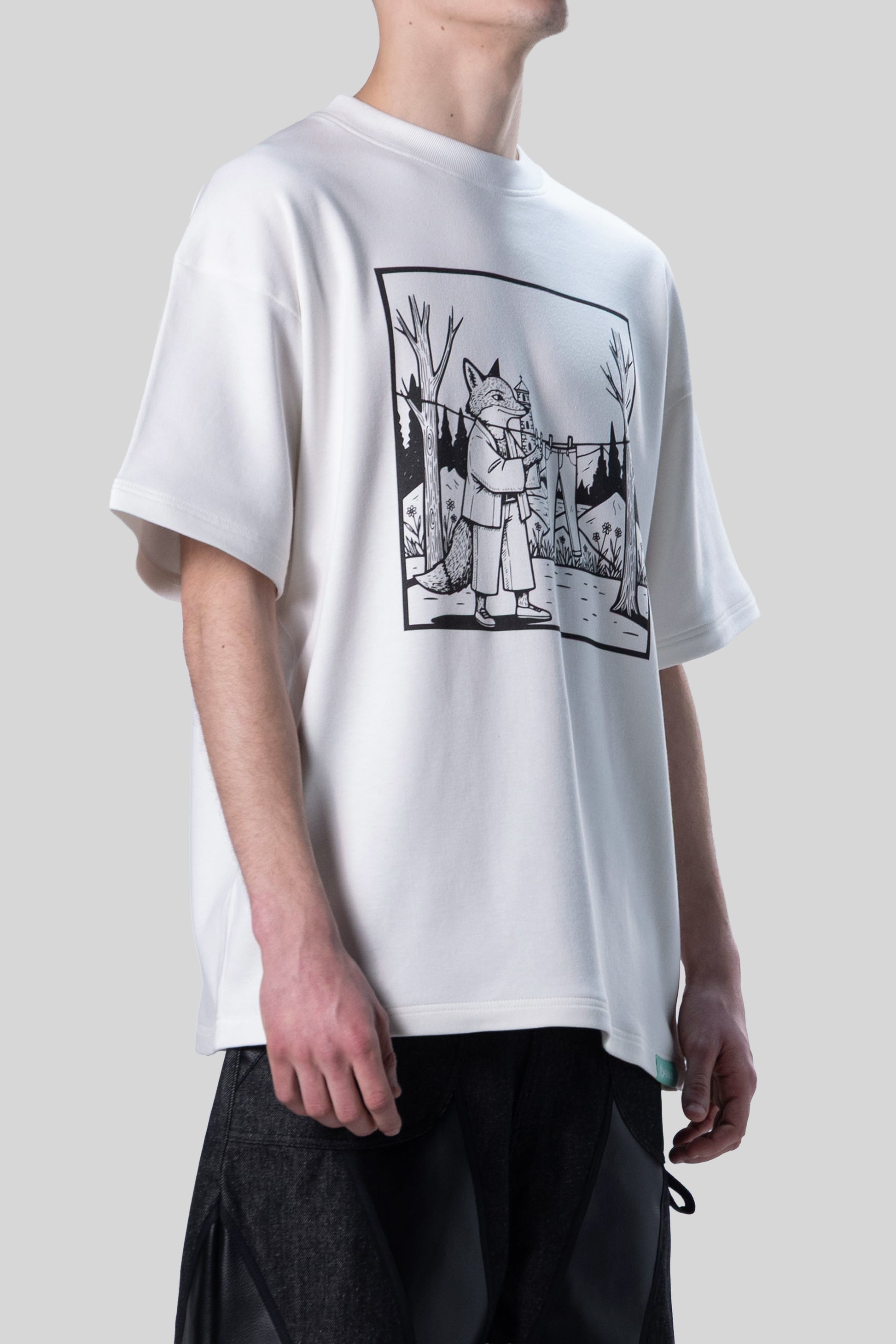 Side view of white Supima cotton Lineage Tee with black DTG print, torso crop