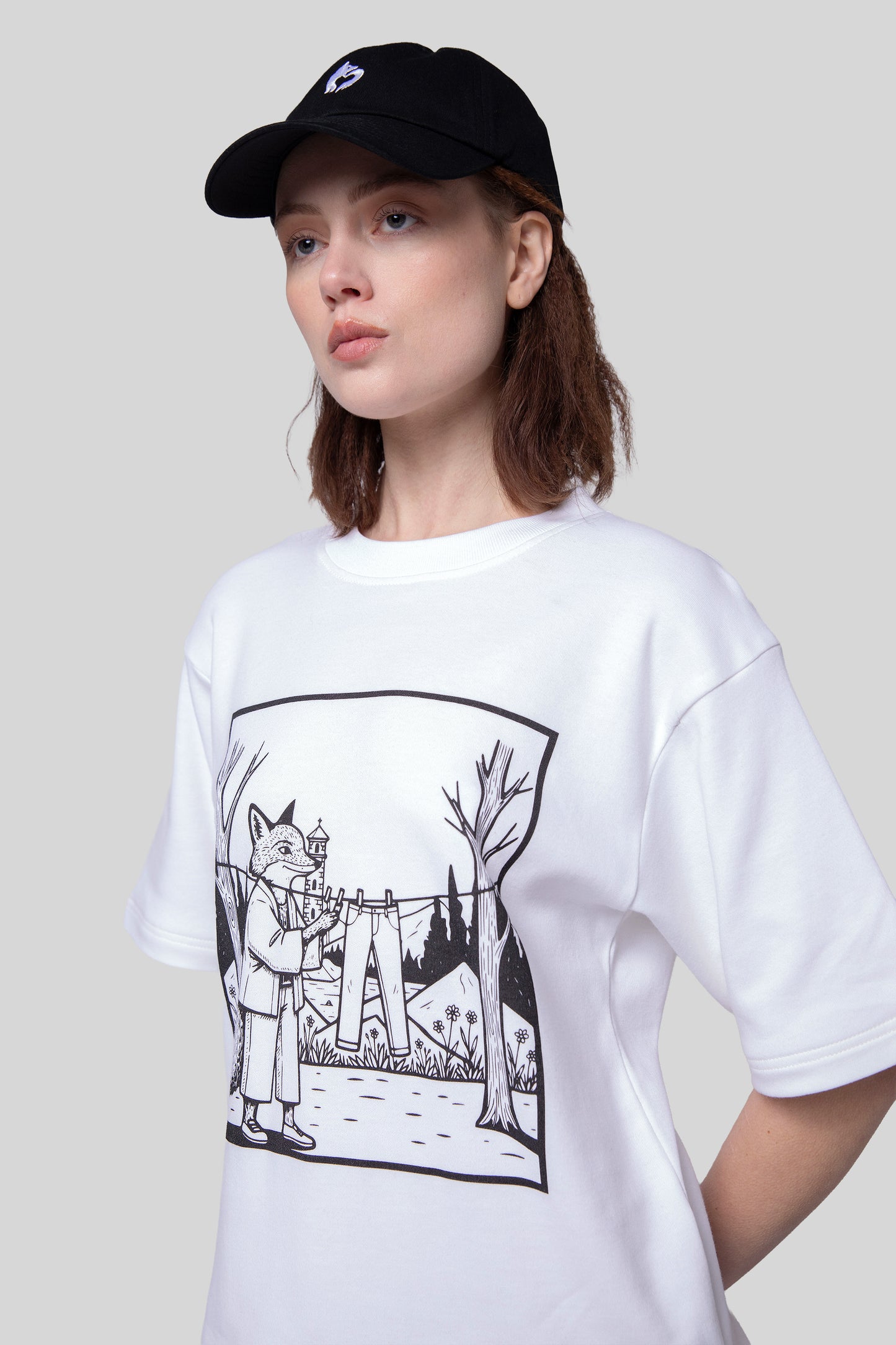 Close-up of white Supima cotton Women’s Lineage Tee with black fox illustration