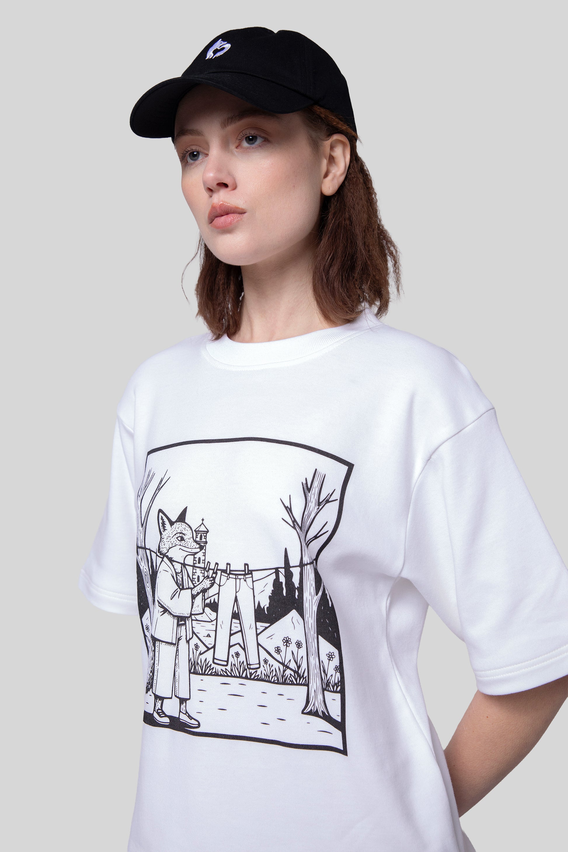 Close-up of white Supima cotton Women’s Lineage Tee with black fox illustration