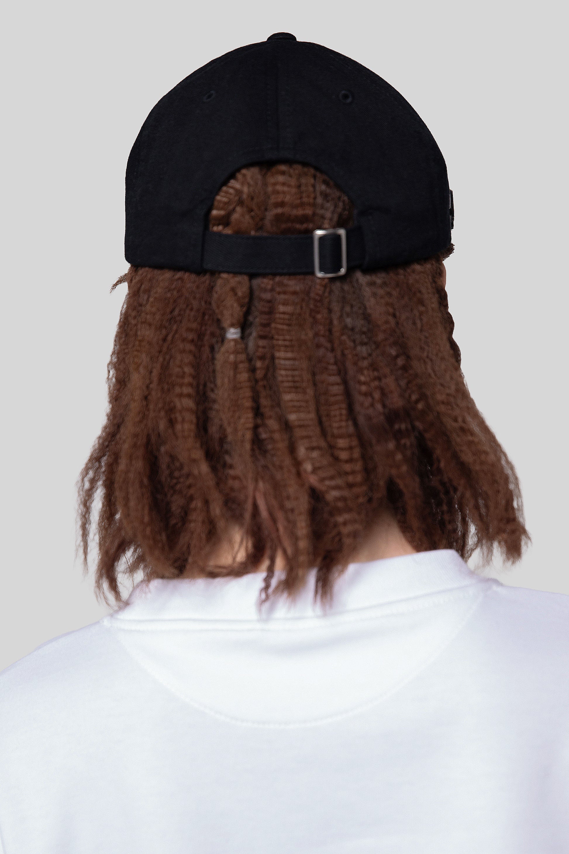 Back view of black No Cap hat with strap closure