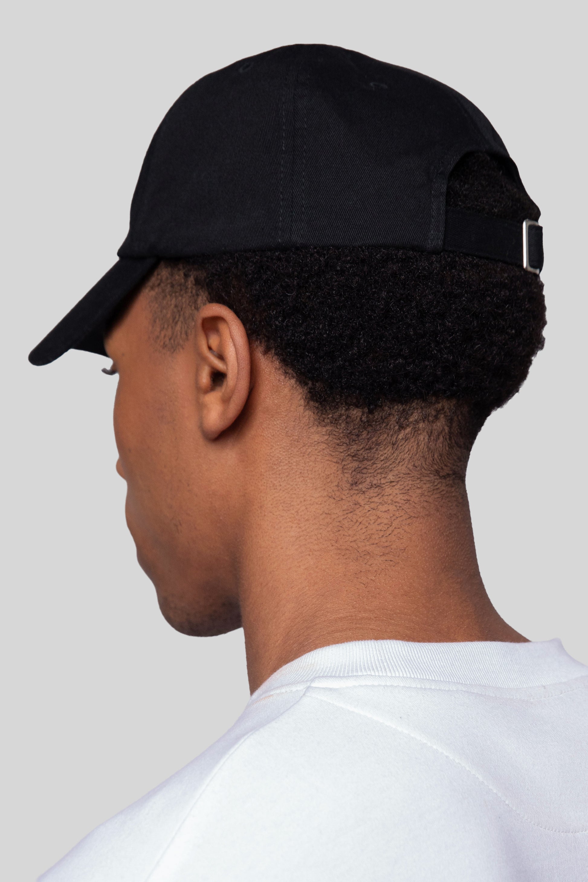 Back view of black No Cap hat with adjustable strap