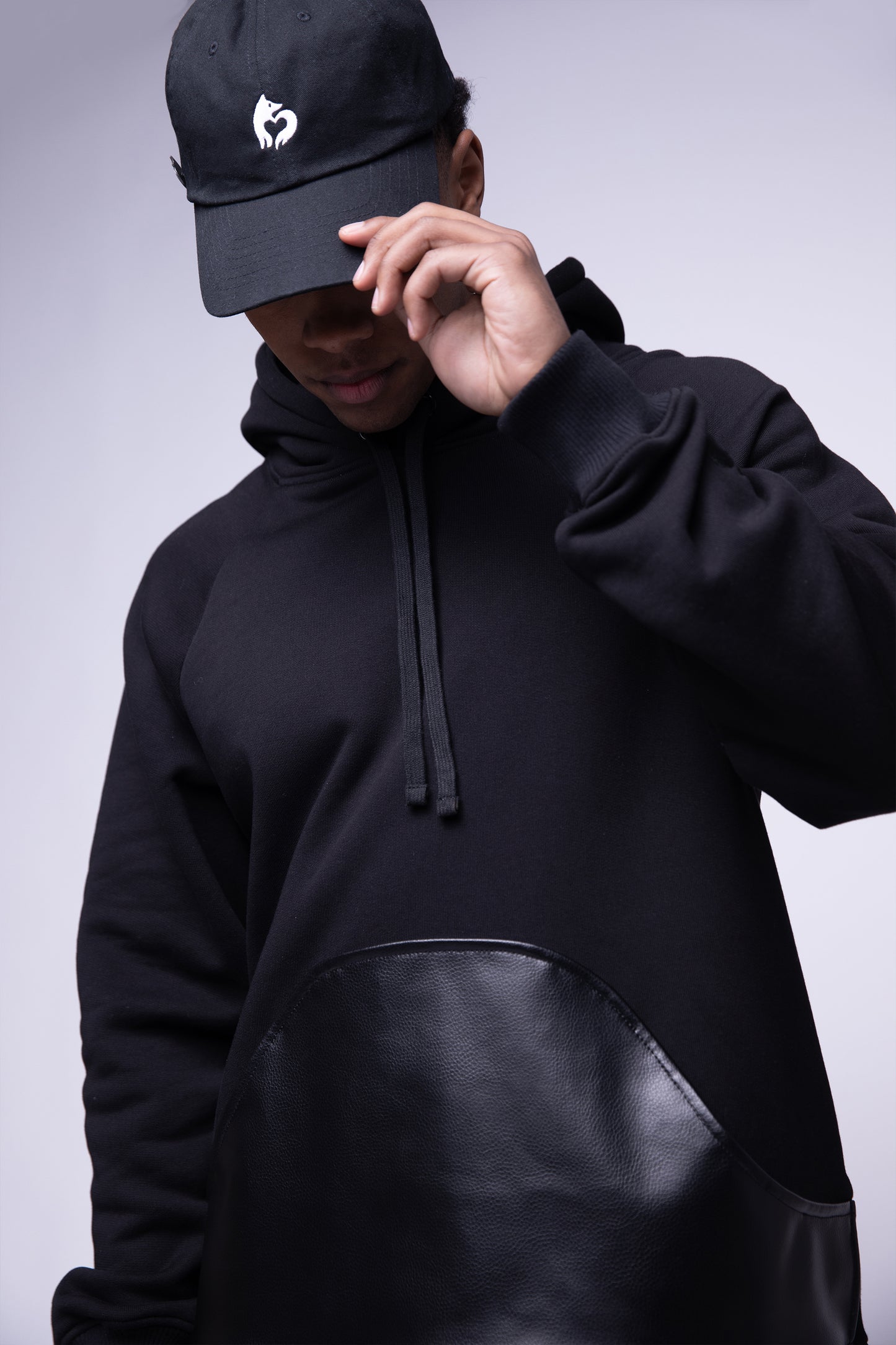 [card:men] Model wearing black No Cap hat in eco-wash cotton, low profile fit, paired with Shadow Hoodie