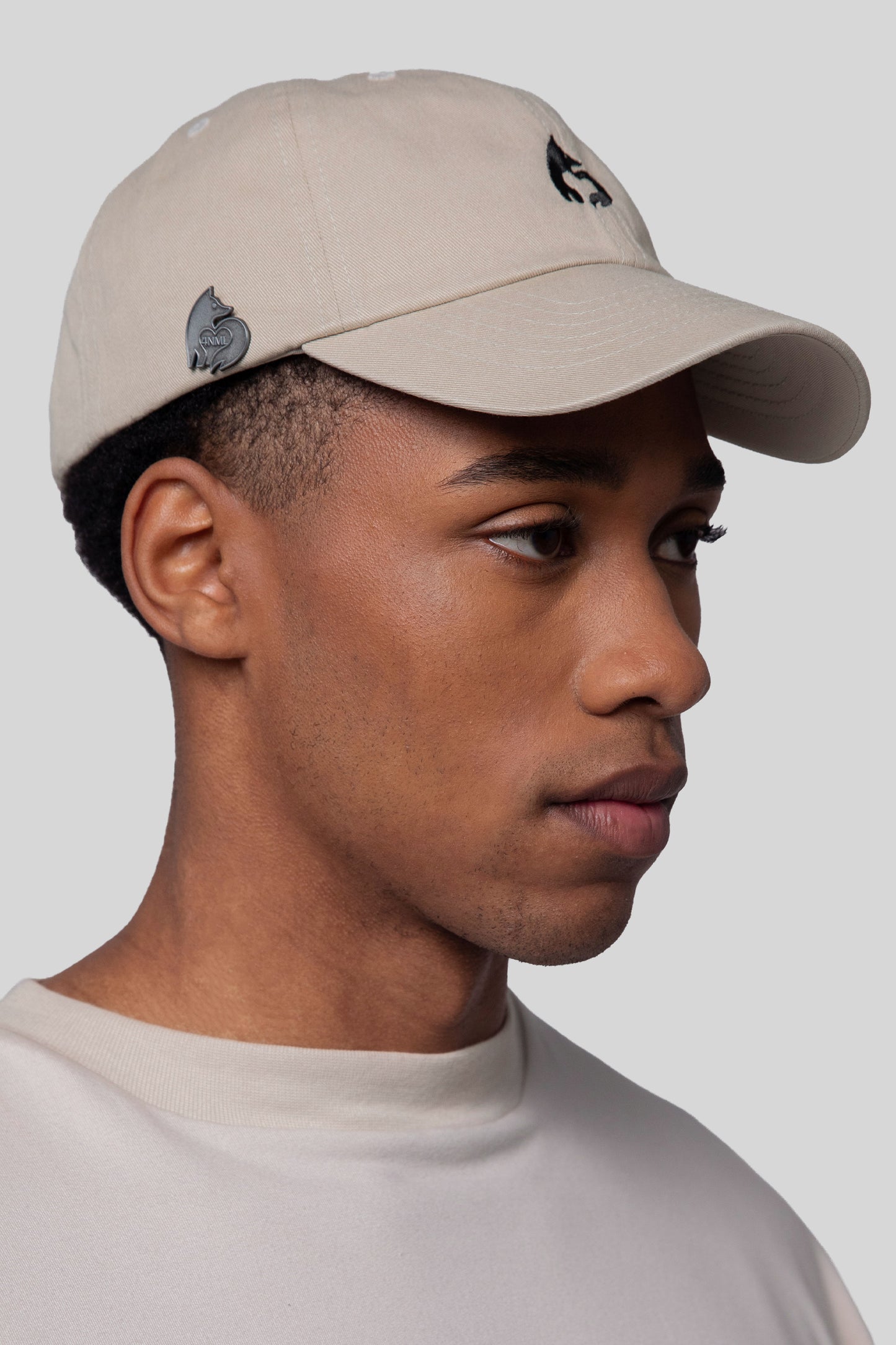 Angled view of oak No Cap hat, low profile fit, die-struck 4NML logo pin