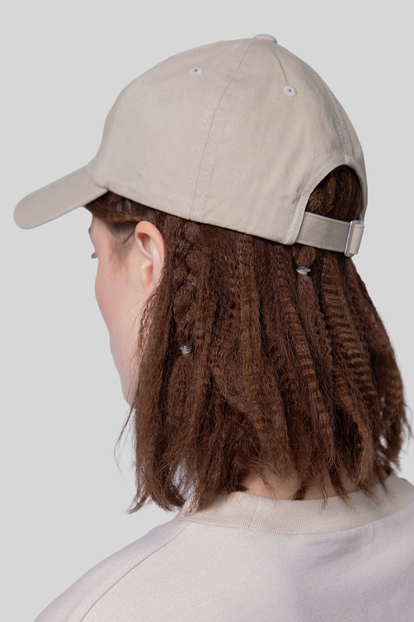 Angled back view of oak No Cap hat, low profile fit, adjustable strap