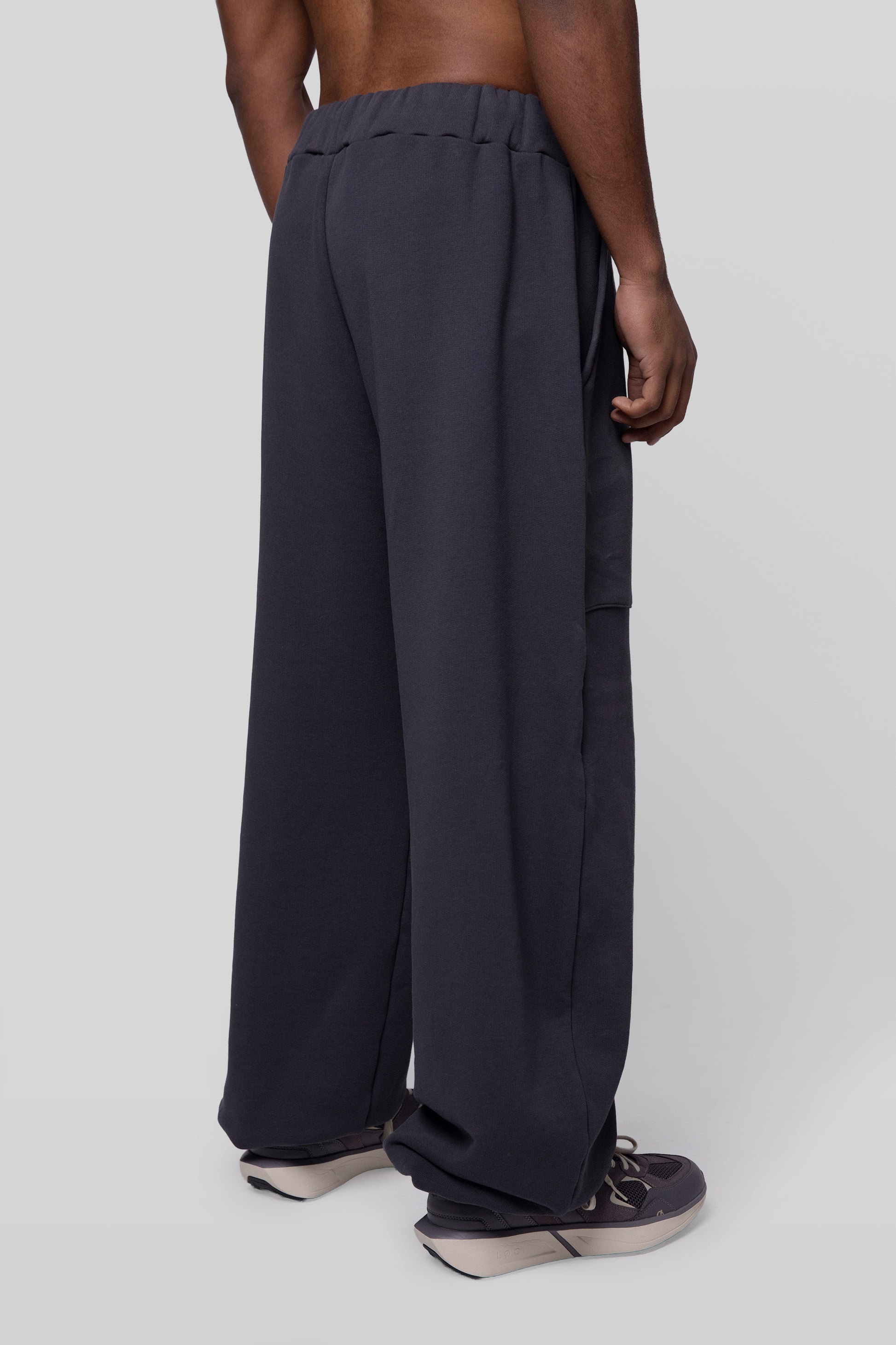 Back angled view of No Sweat pants in deep grey organic cotton