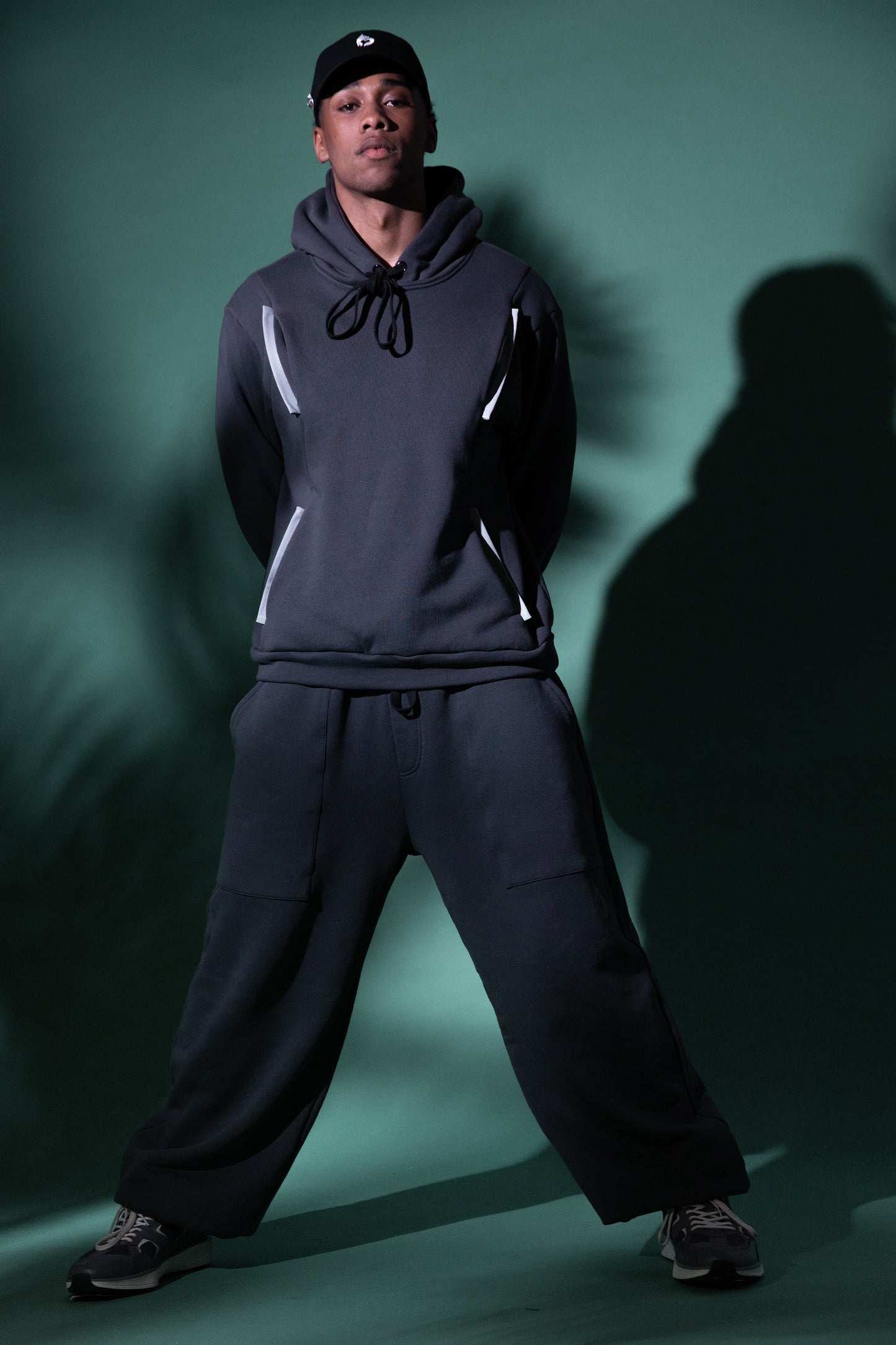Model wearing deep grey No Sweat pants with relaxed fit and ribbed ankle cuffs
