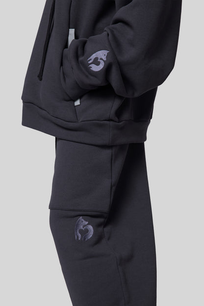 [card:women-secondary] Close-up of side leg on deep grey No Sweat pants and matching Anchor Hoodie
