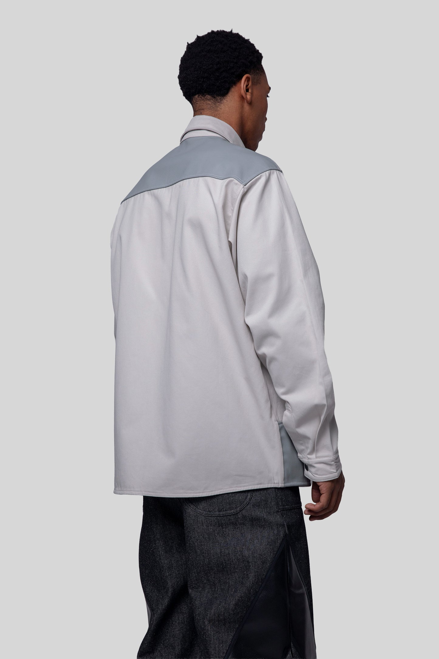 Back angled view of Out of Pocket shirt with panel detail