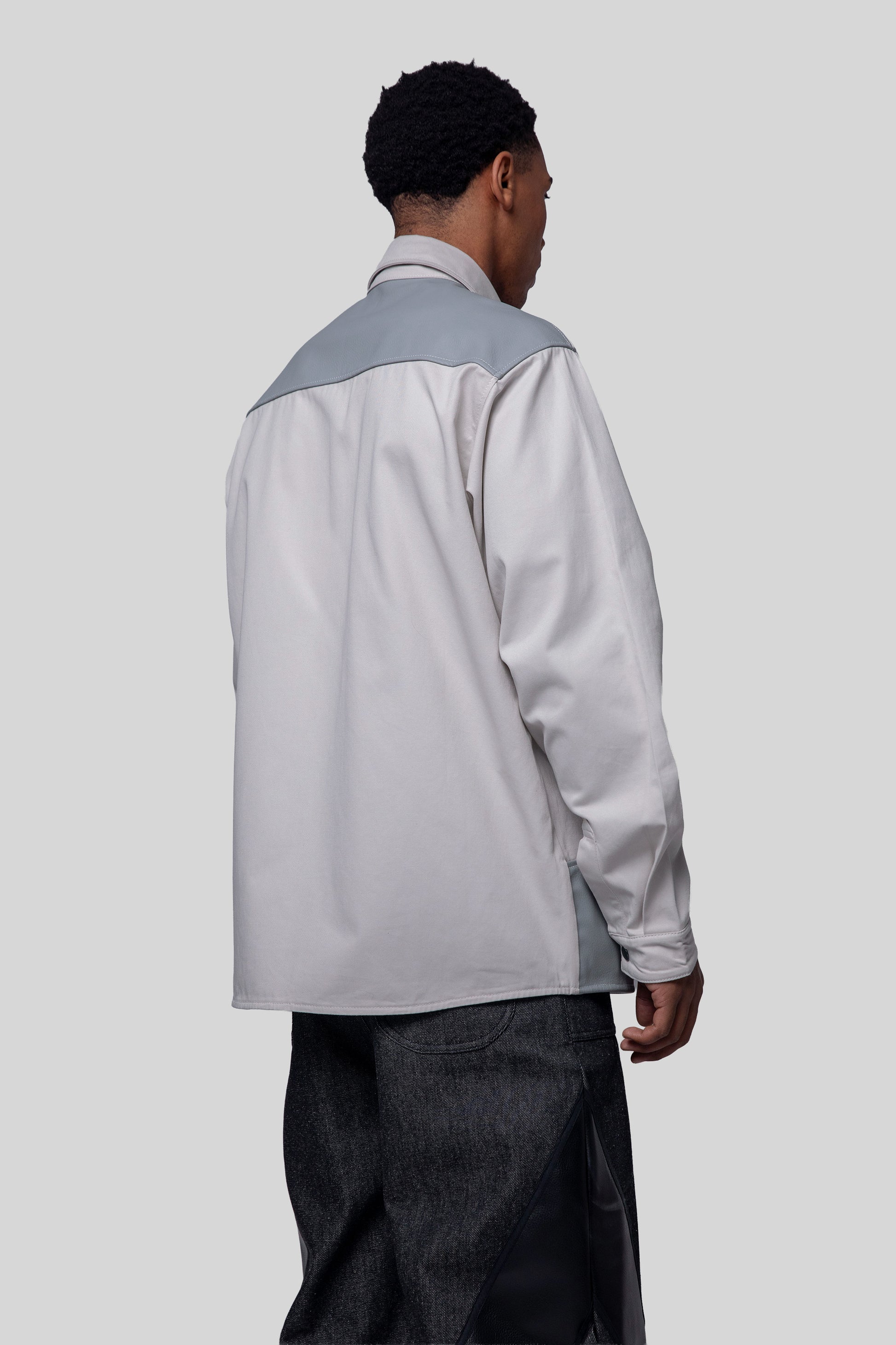 Back angled view of Out of Pocket shirt with panel detail