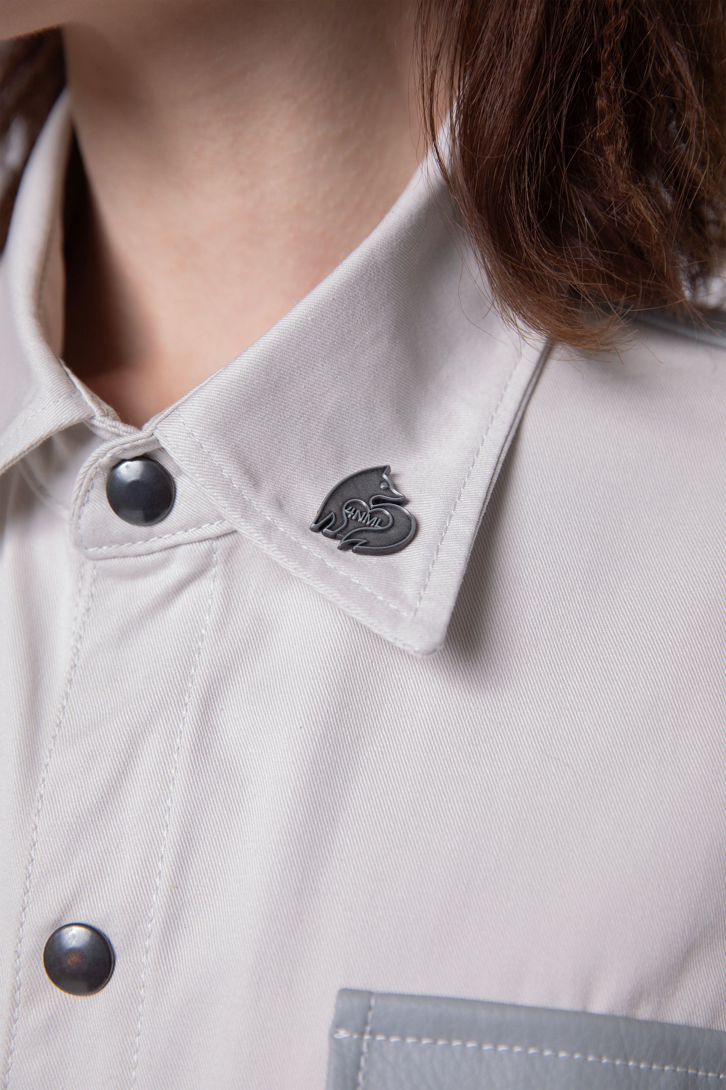Close-up of collar, snap button detail, and silver 4NML logo pin on Out of Pocket shirt
