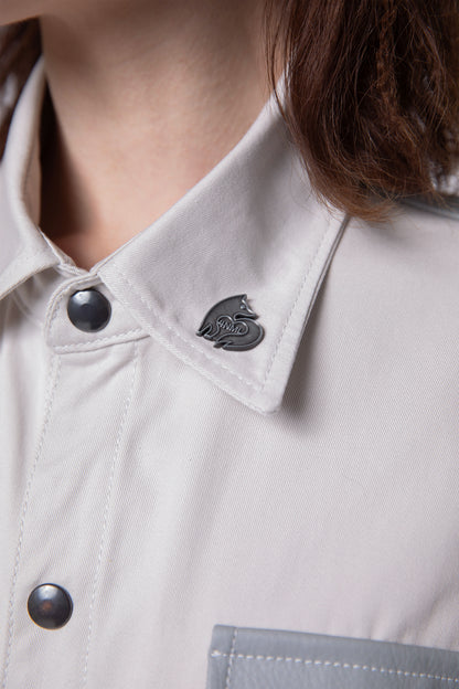 Close-up of collar, snap button detail, and silver 4NML logo pin on Out of Pocket shirt