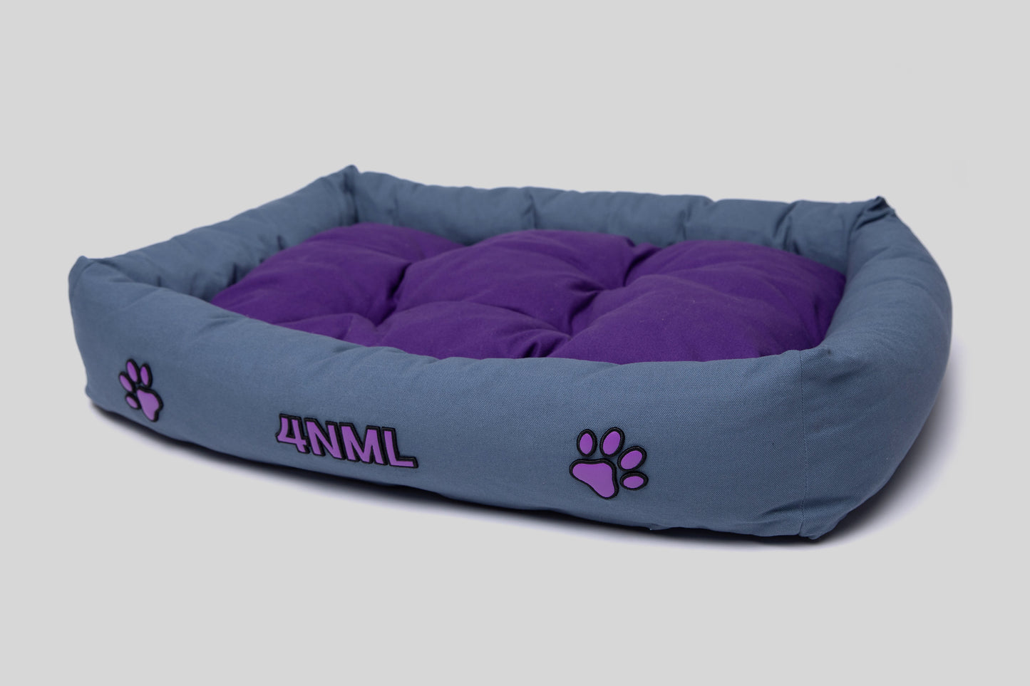 Angled view of canvas cotton pet bed with lavender AppleSkin embroidery, blue base with purple cushion