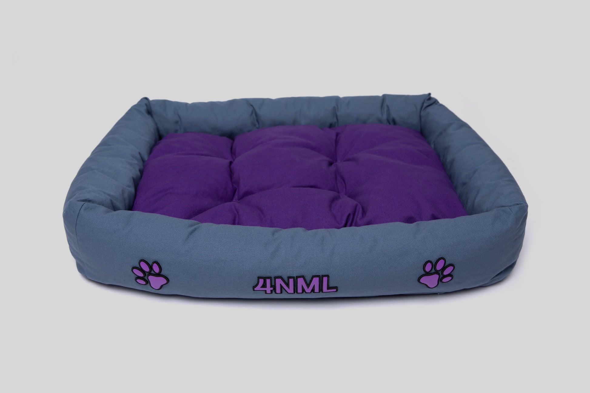 Angled view of canvas cotton pet bed with lavender AppleSkin embroidery, blue and purple