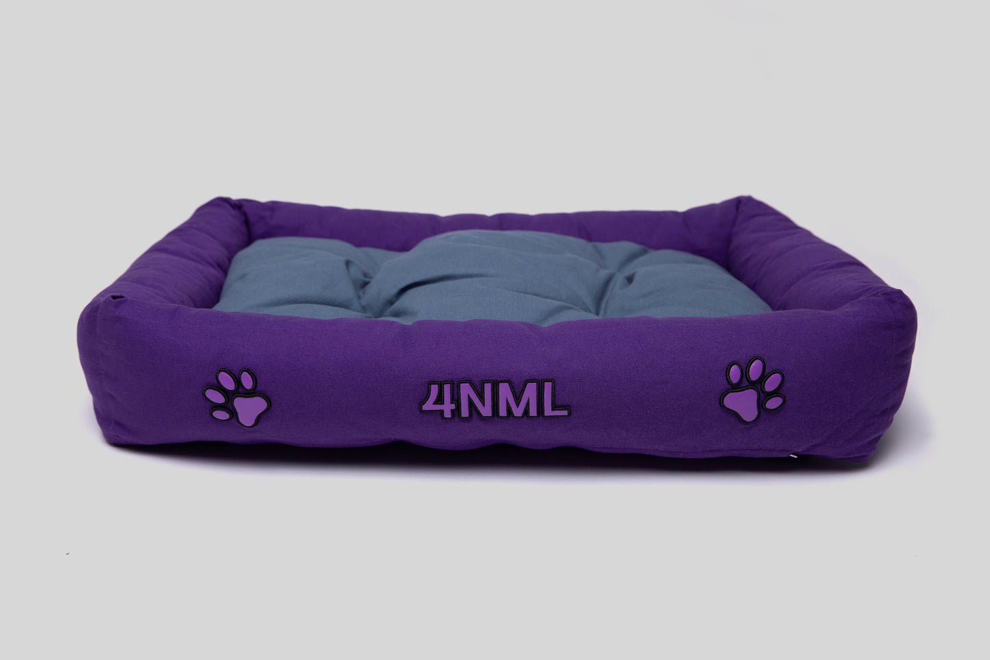 Top angled view of canvas cotton pet bed with tufted cushion, purple and blue colorway