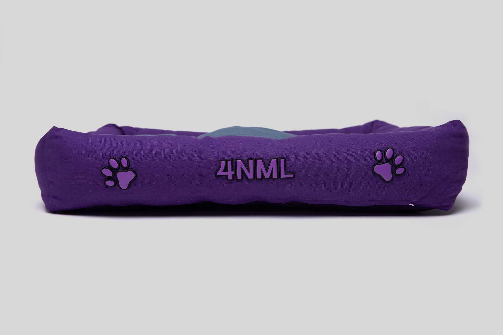 Side view of canvas cotton pet bed with lavender AppleSkin embroidery, purple base