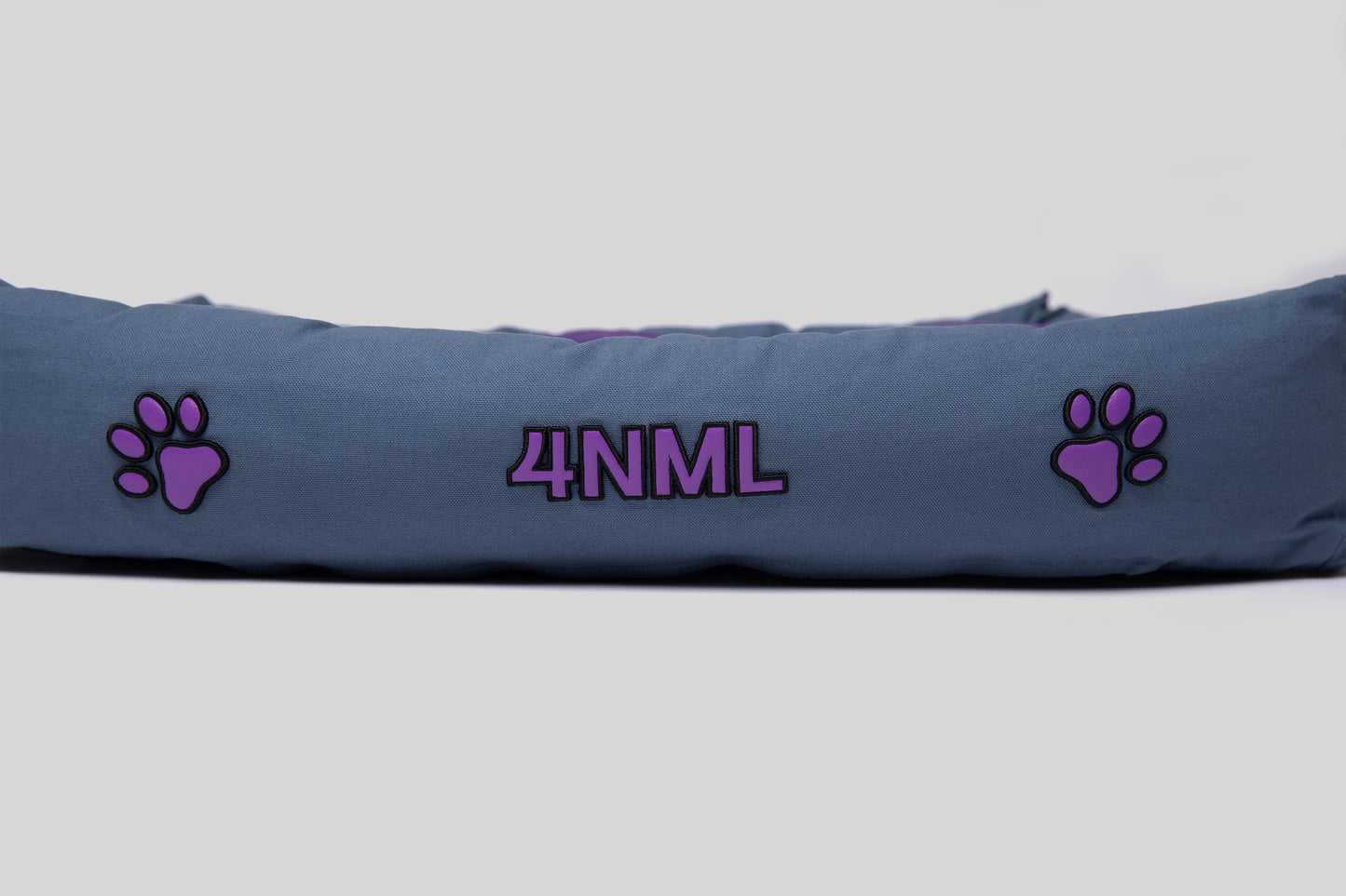 Extended side view of blue canvas cotton pet bed with lavender AppleSkin embroidery