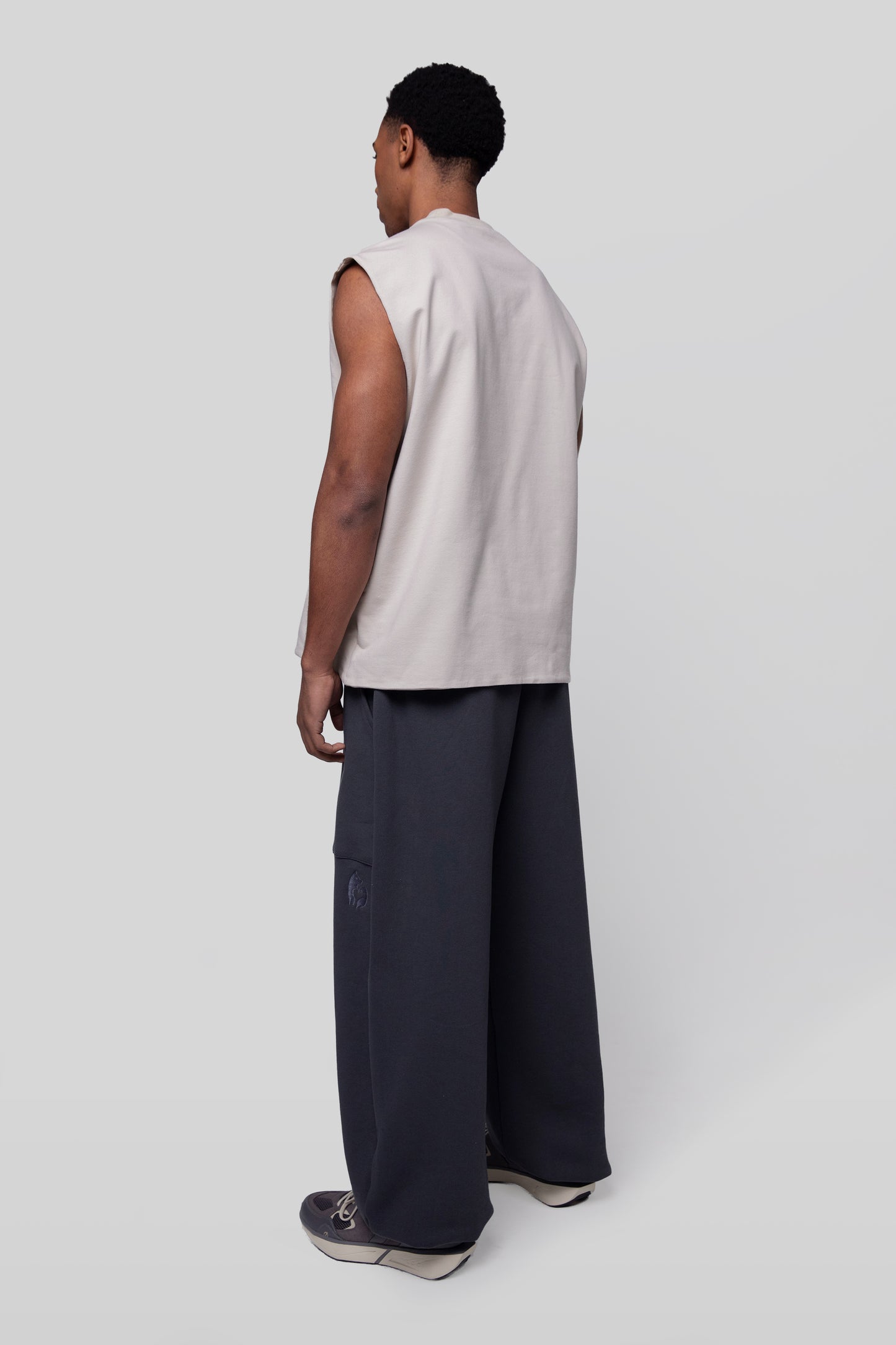 Back angled view of Rough Draft tank in off-white organic cotton